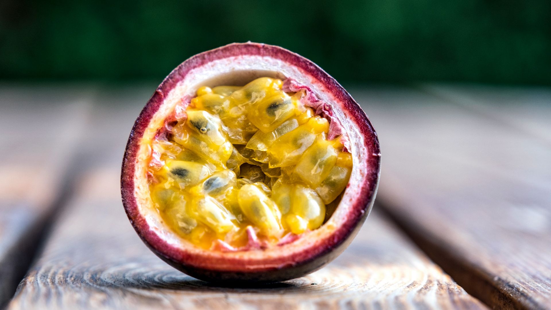 red and yellow round fruit on brown wooden table