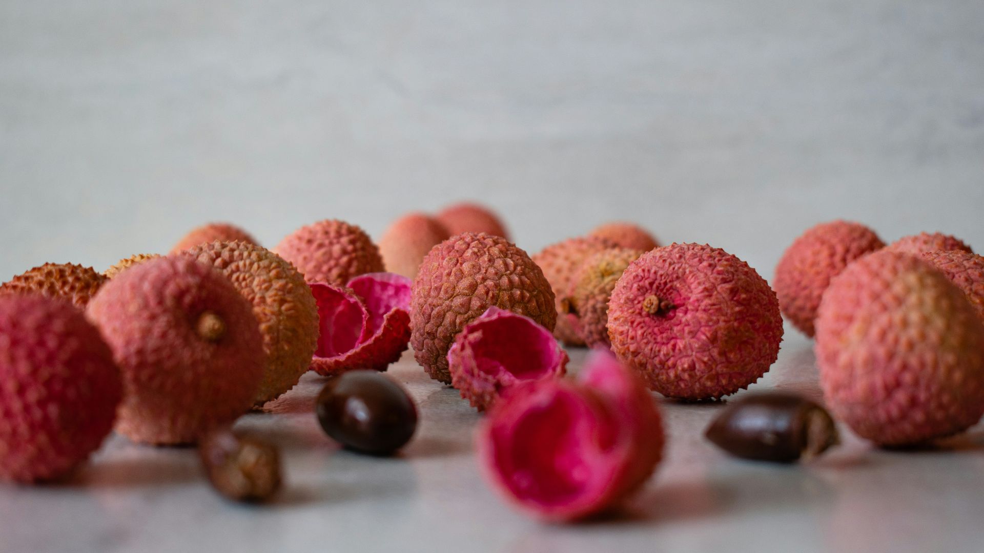 brown and pink round fruit on white table