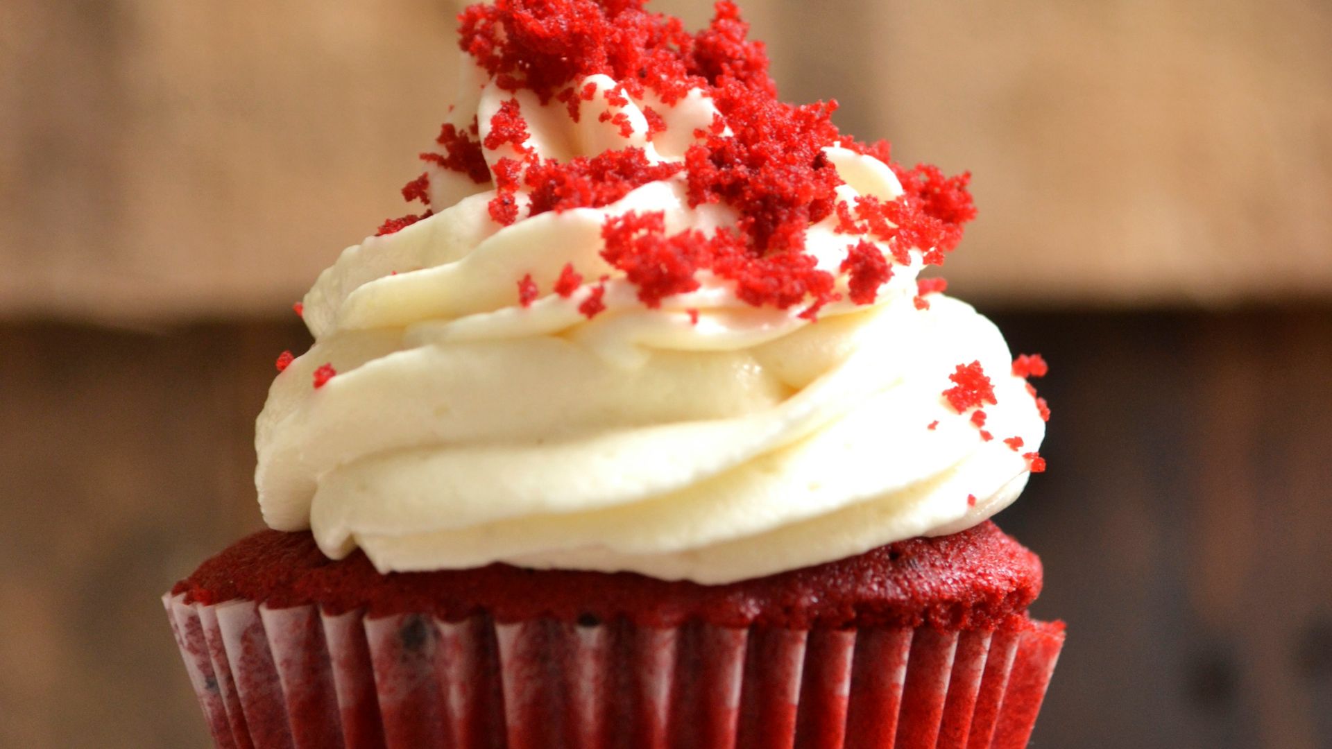 white and red cupcake with white icing on top