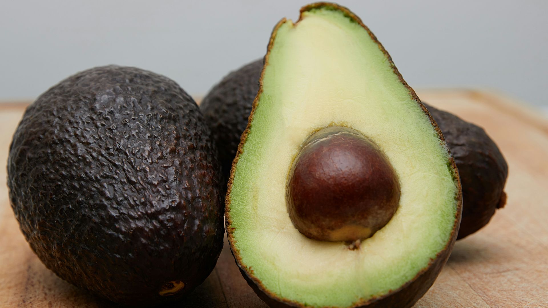 sliced avocado fruit on brown wooden table