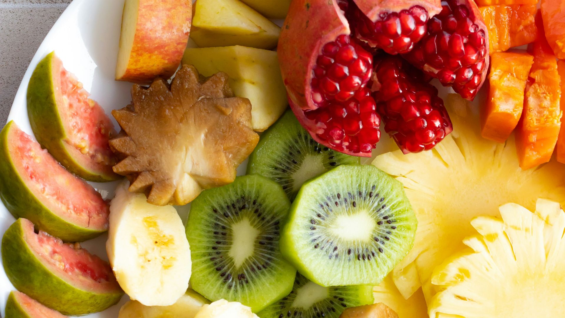 a white plate topped with cut up fruit