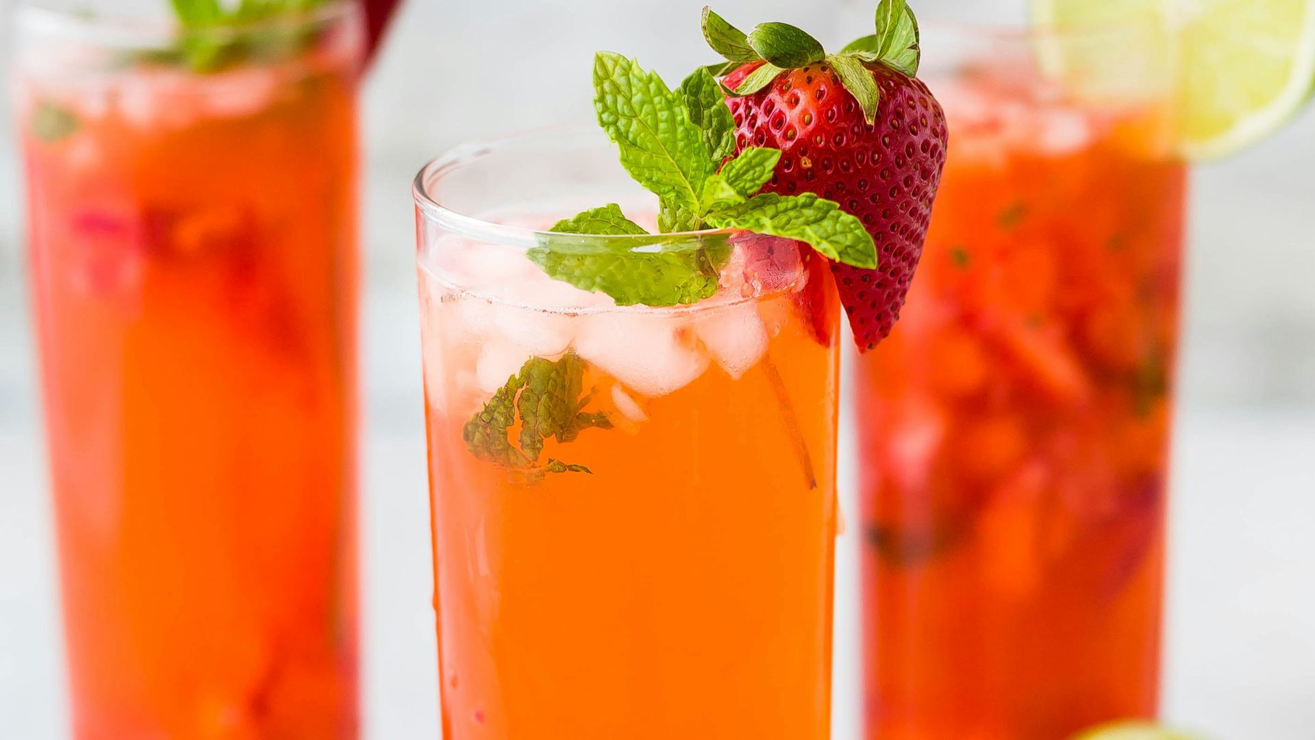 three clear drinking glasses filled with juice