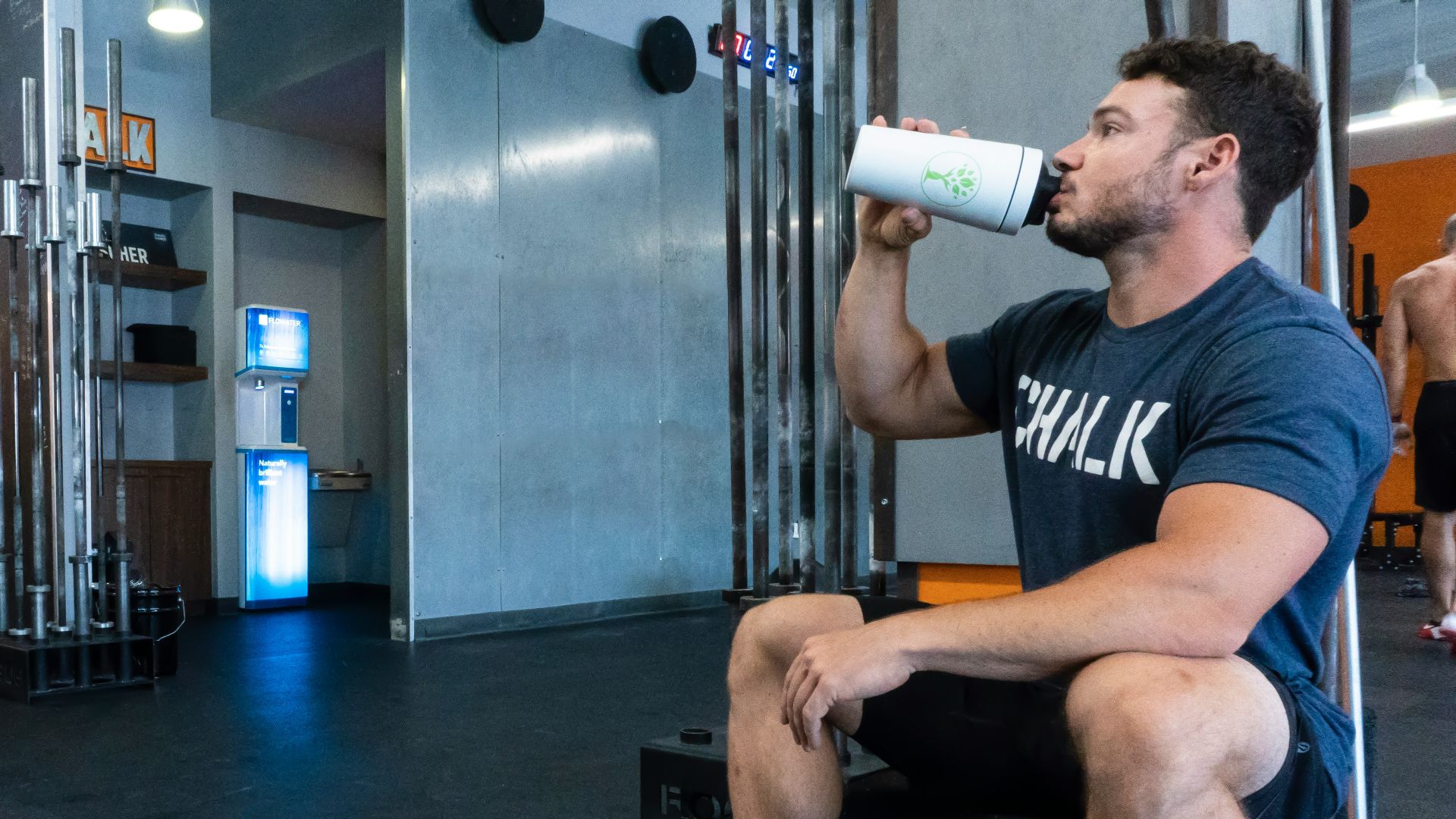 person in black and white nike sneakers sitting on black leather couch