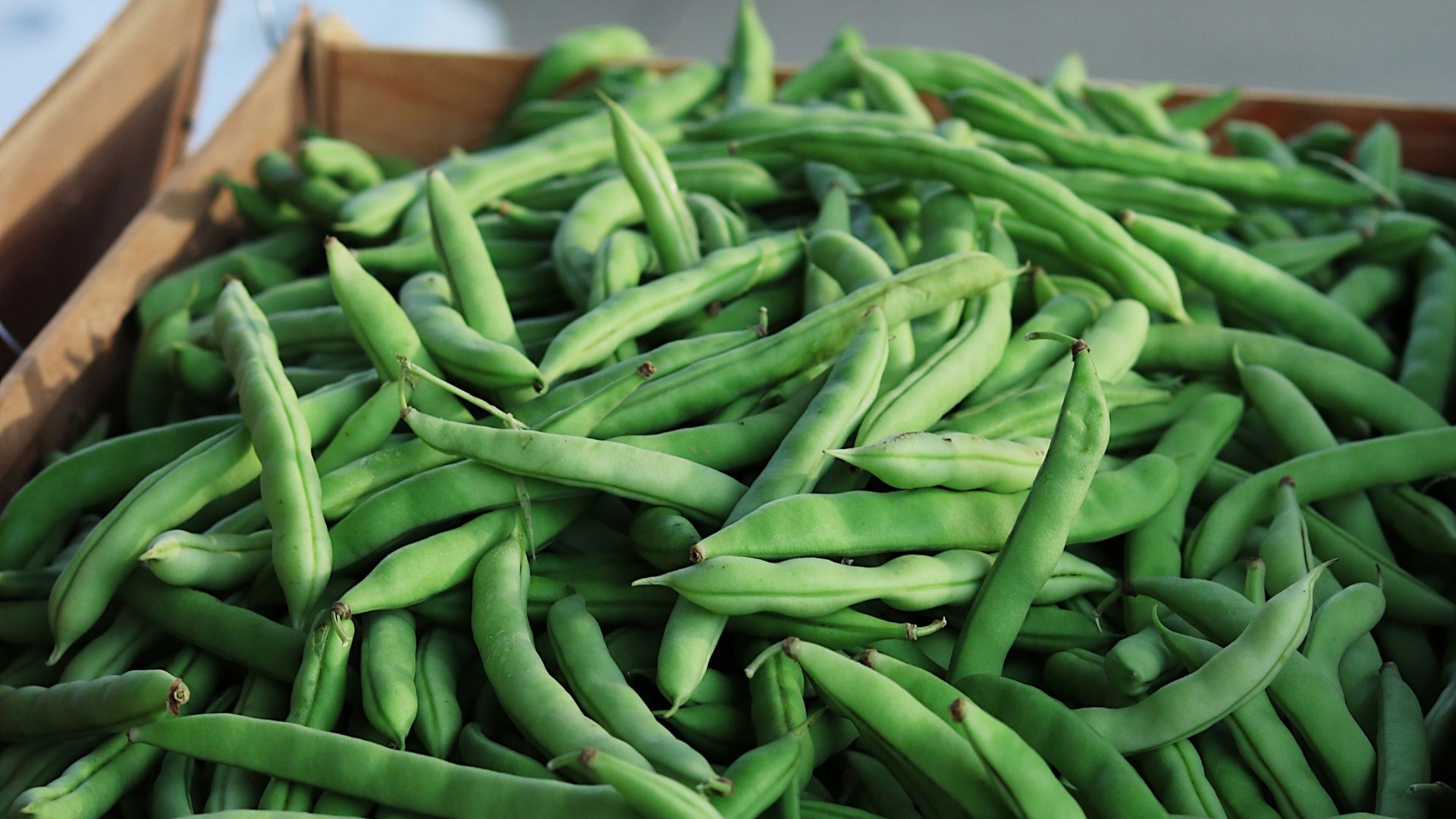 green string beans on brown wooden crate