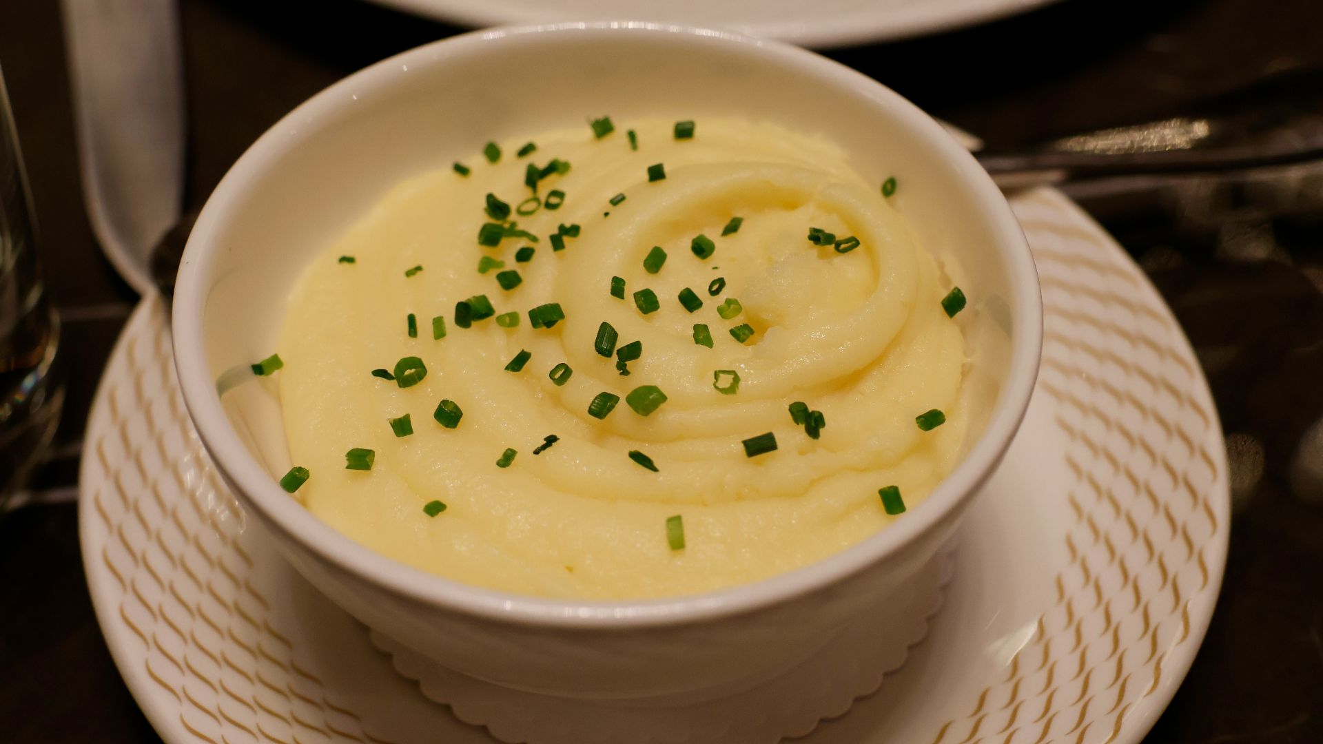 a bowl of mashed potatoes topped with chives