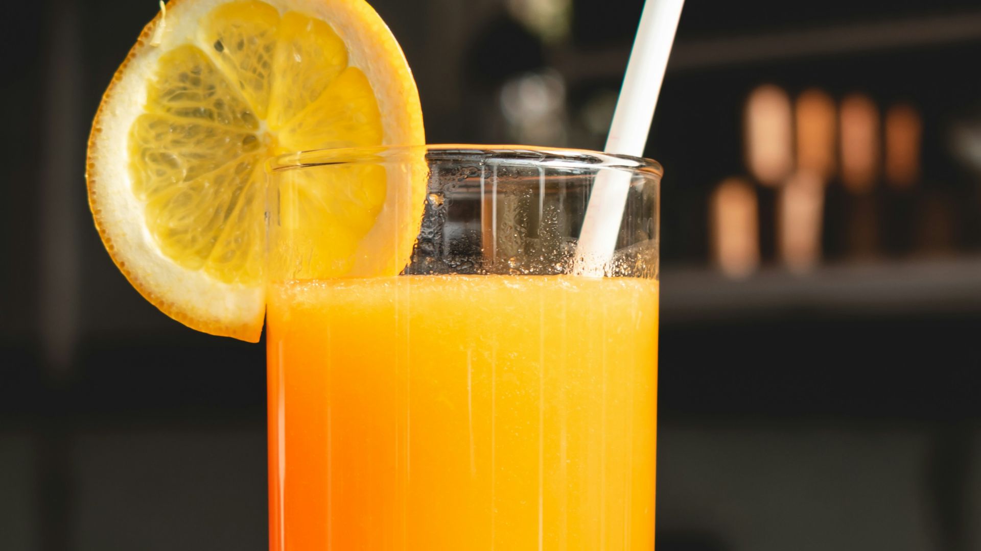 orange juice in clear drinking glass