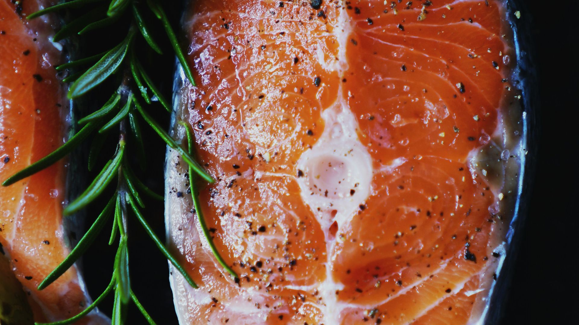 sliced orange fruit on black textile