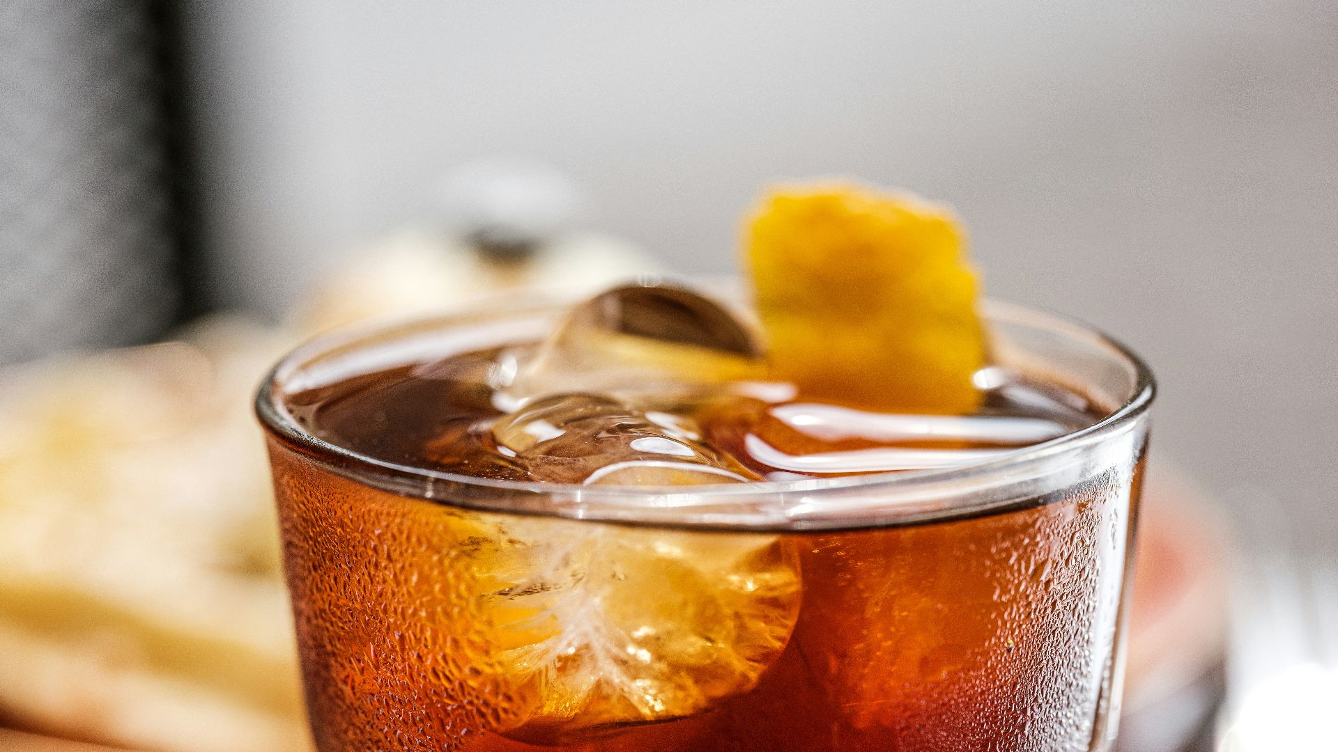 clear drinking glass with brown liquid and ice