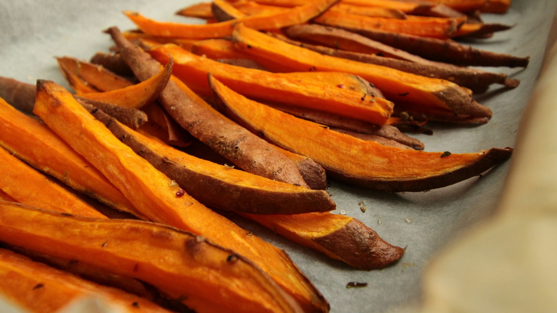 sliced orange fruit on white table