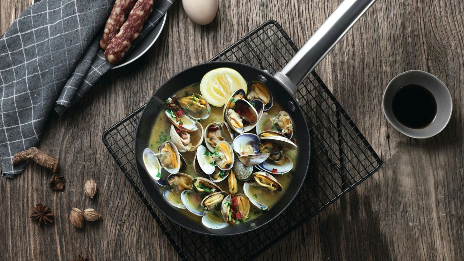 black cast iron pan with cooked food on brown wooden table