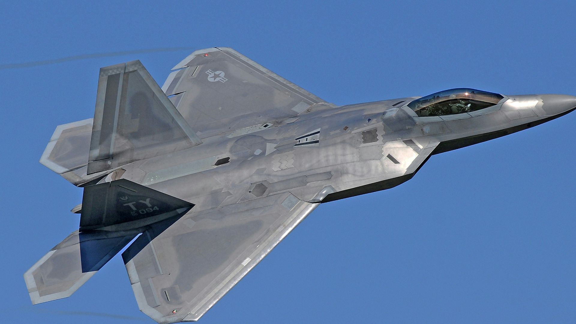 flying gray jet plane