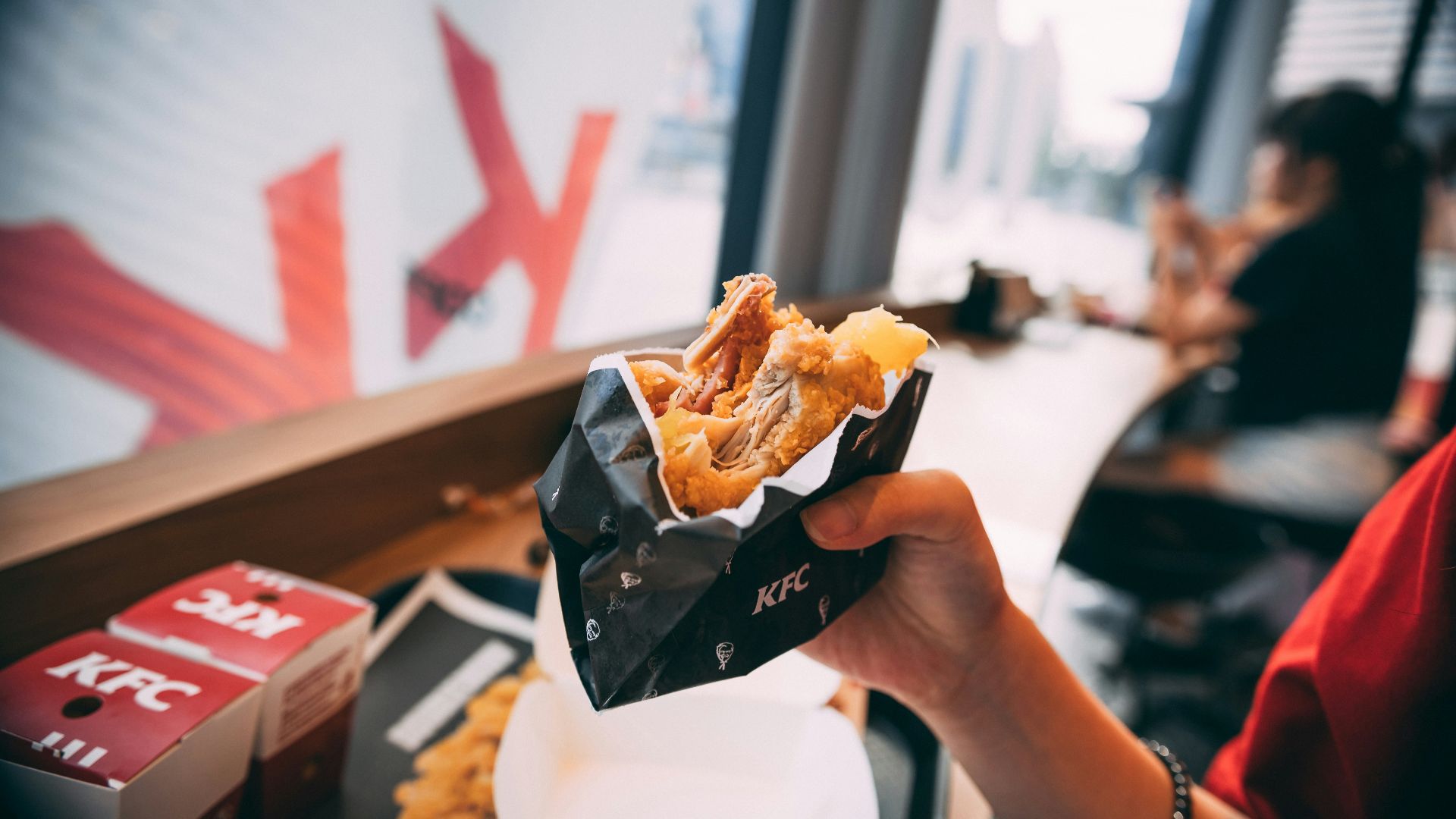 person holding black and white plastic pack