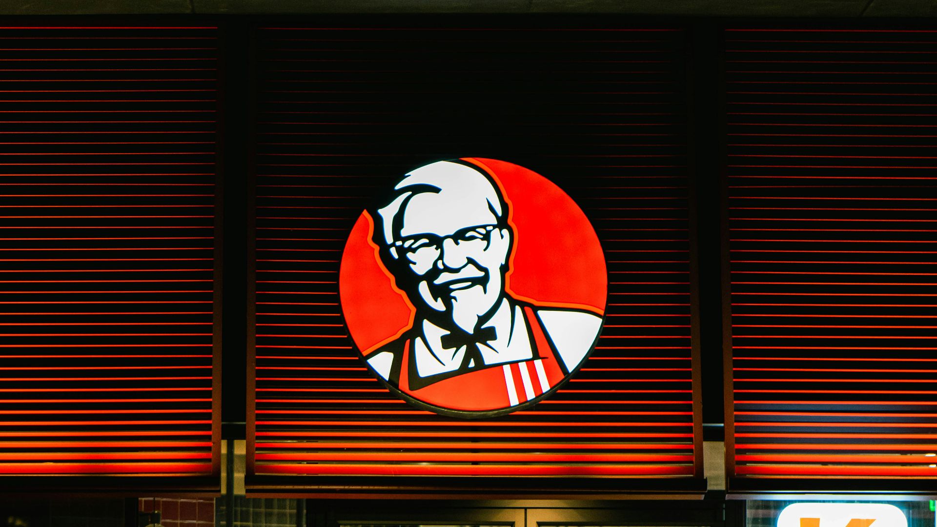 a store front with a lit up sign above it