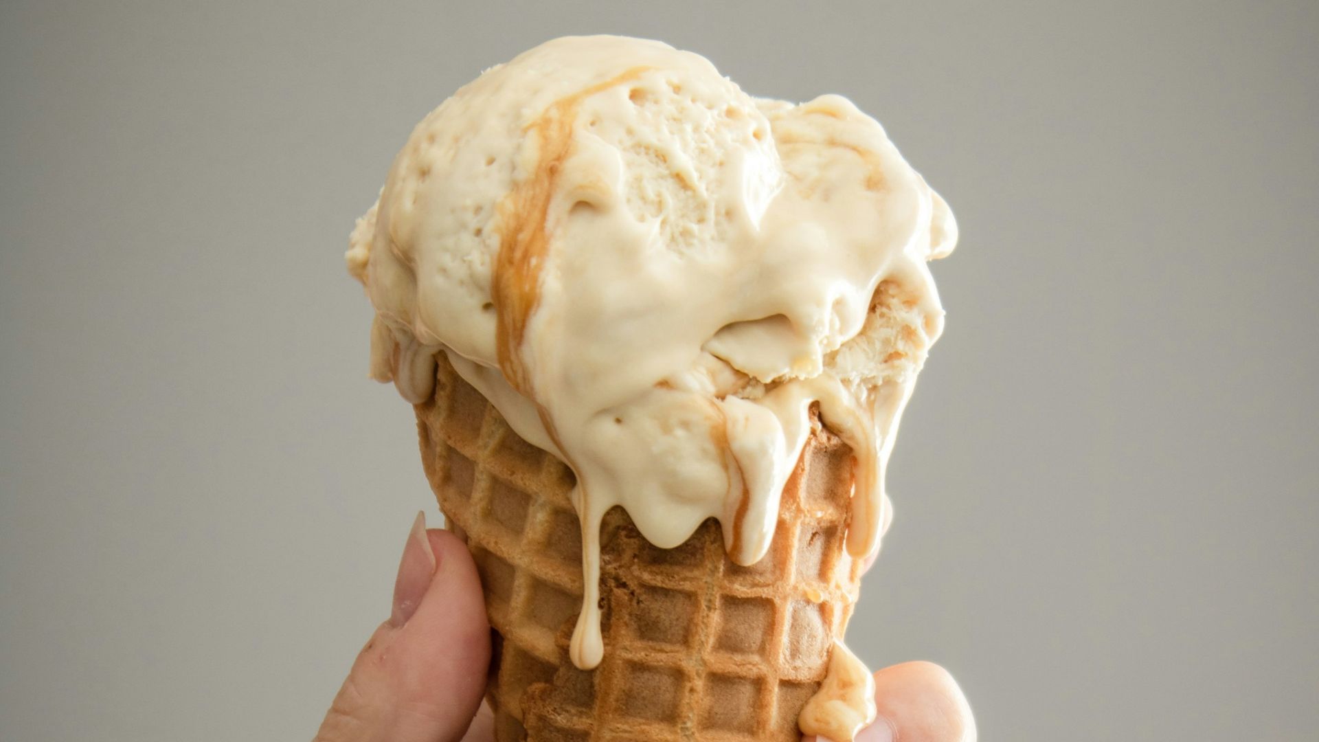 white ice cream on brown cone