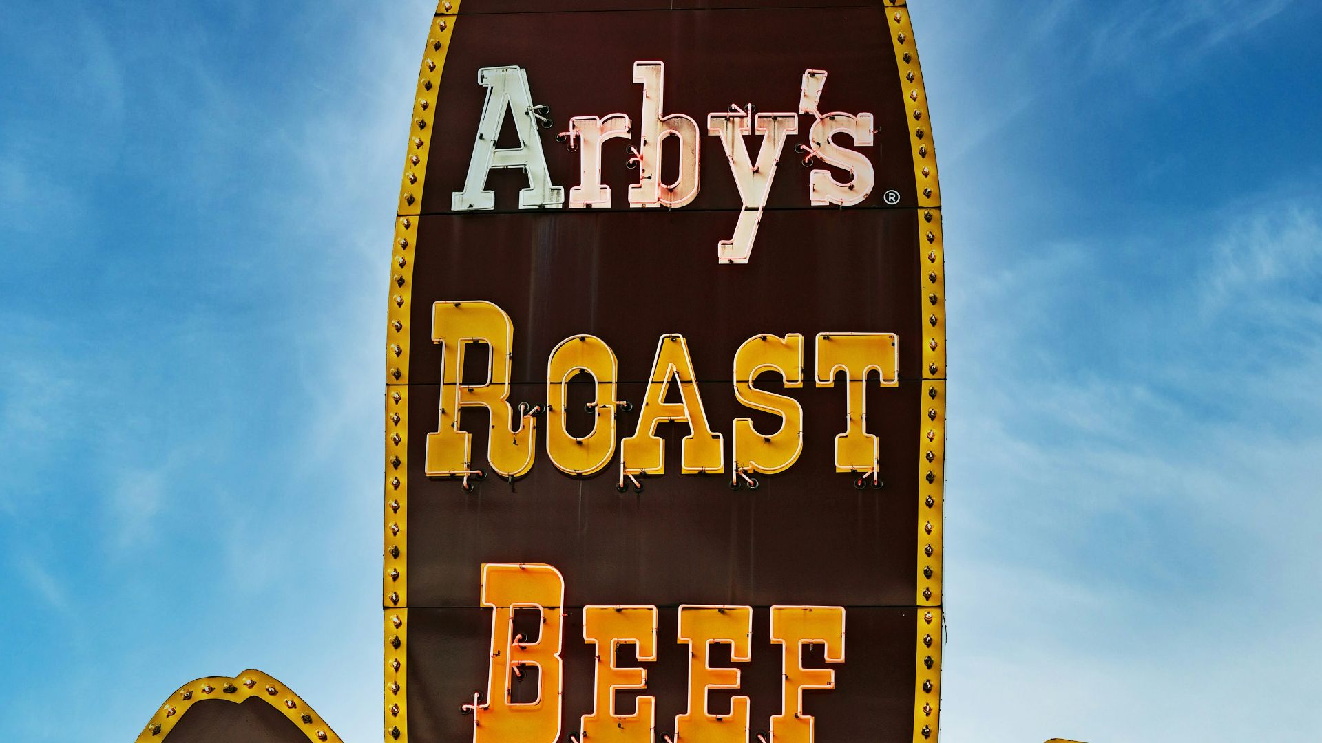 A sign for a restaurant called andy's roast beef sandwich