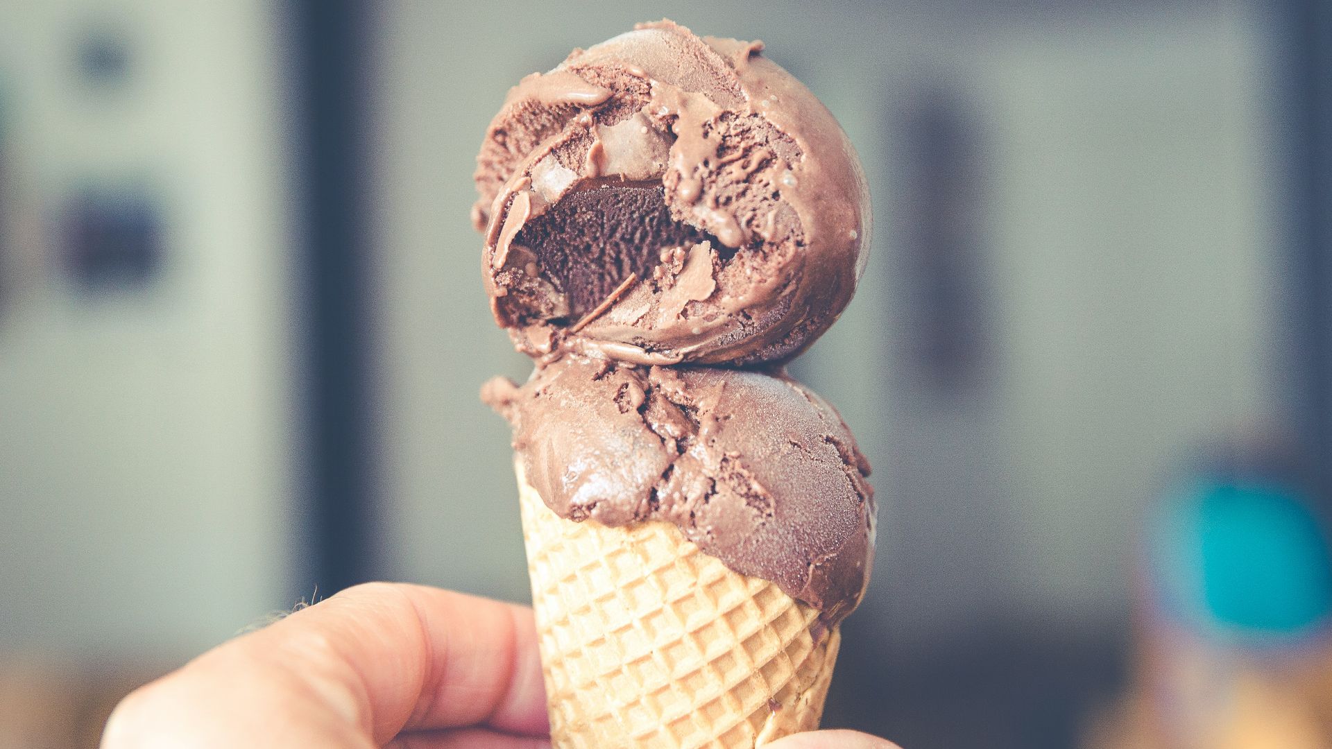 selective focus photography of chocolate ice cream on brown cone