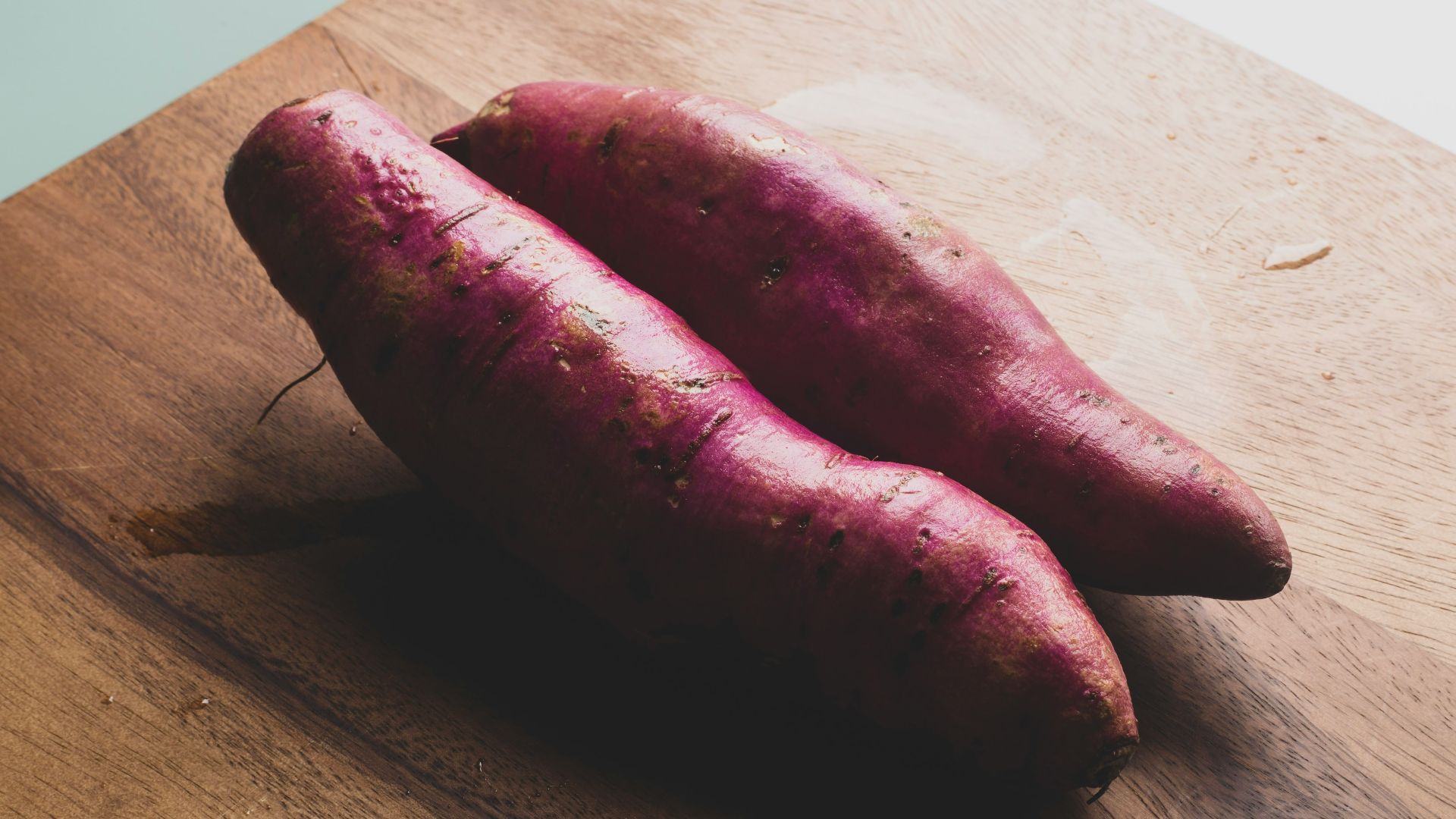 two red sausage on brown wooden chopping board