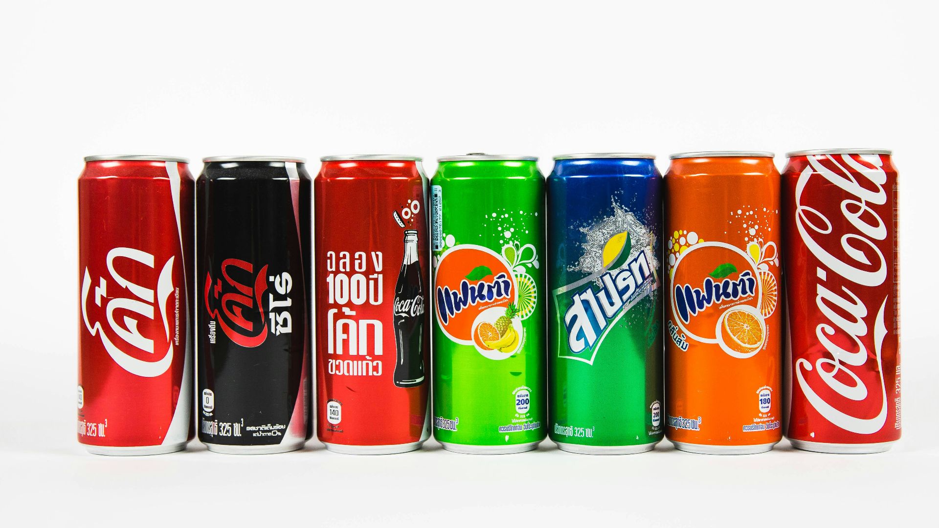 seven assorted-brand soda cans