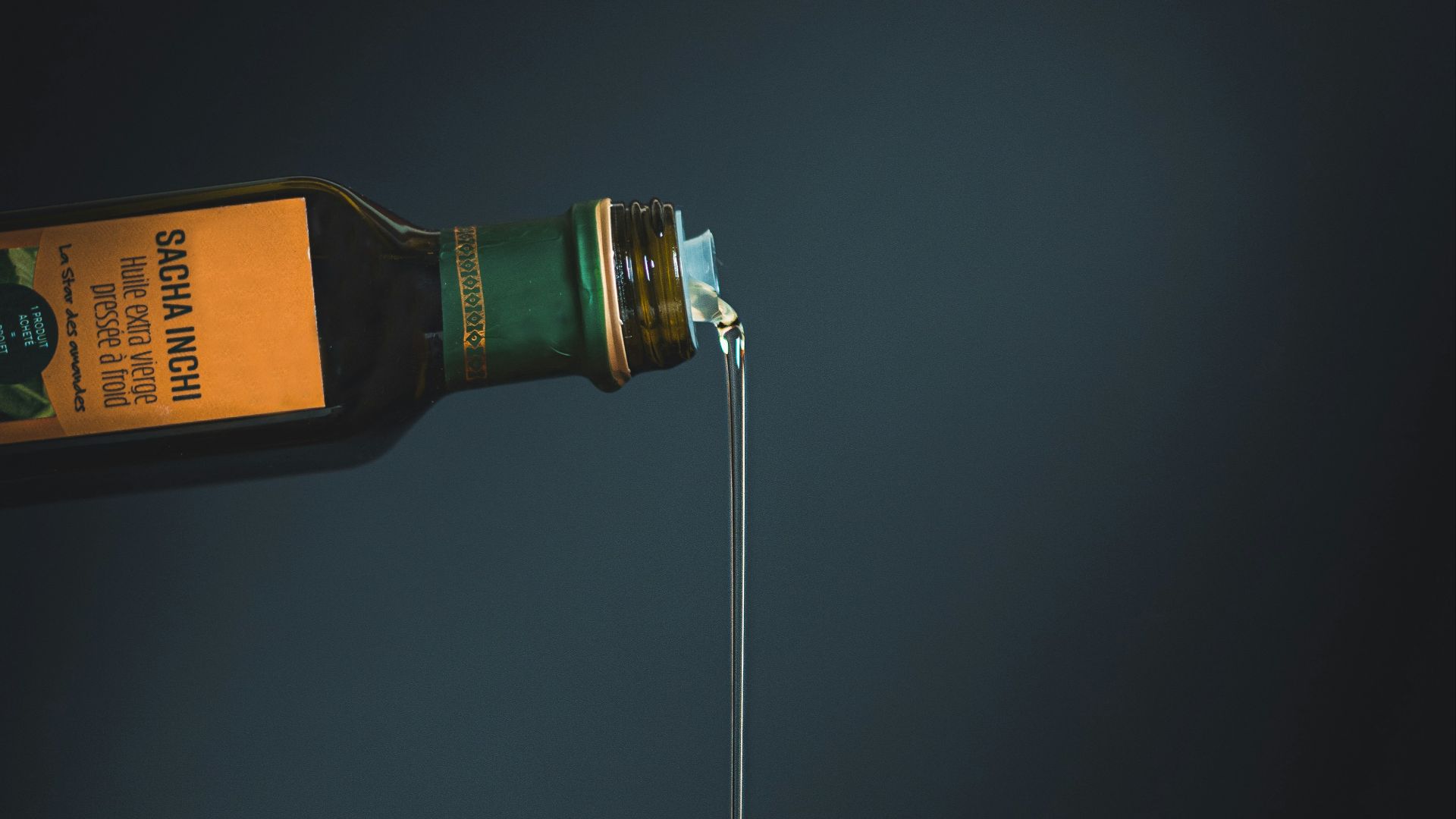 bottle with white liquid pouring through the brown slab