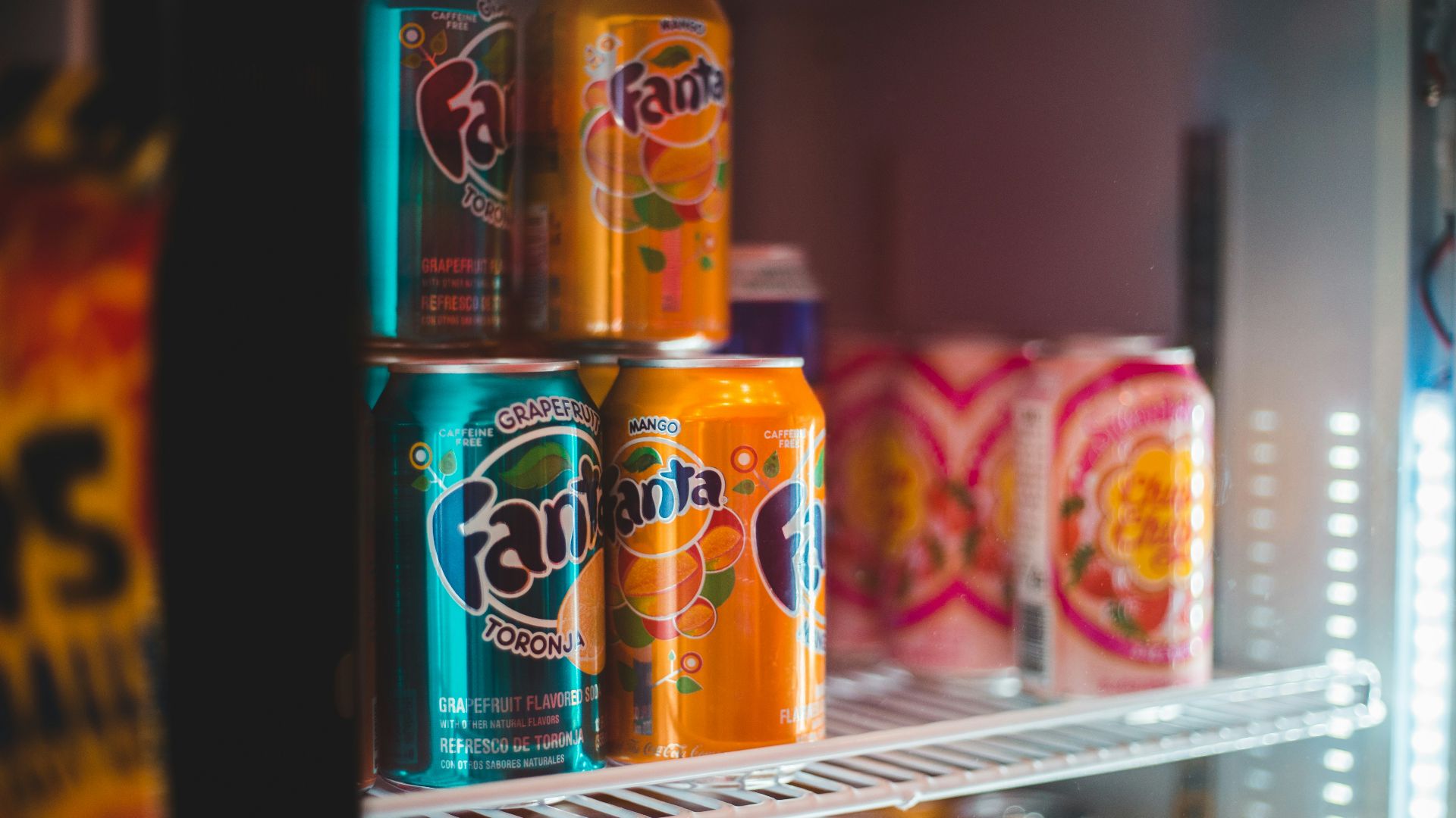 fanta orange soda can on white shelf
