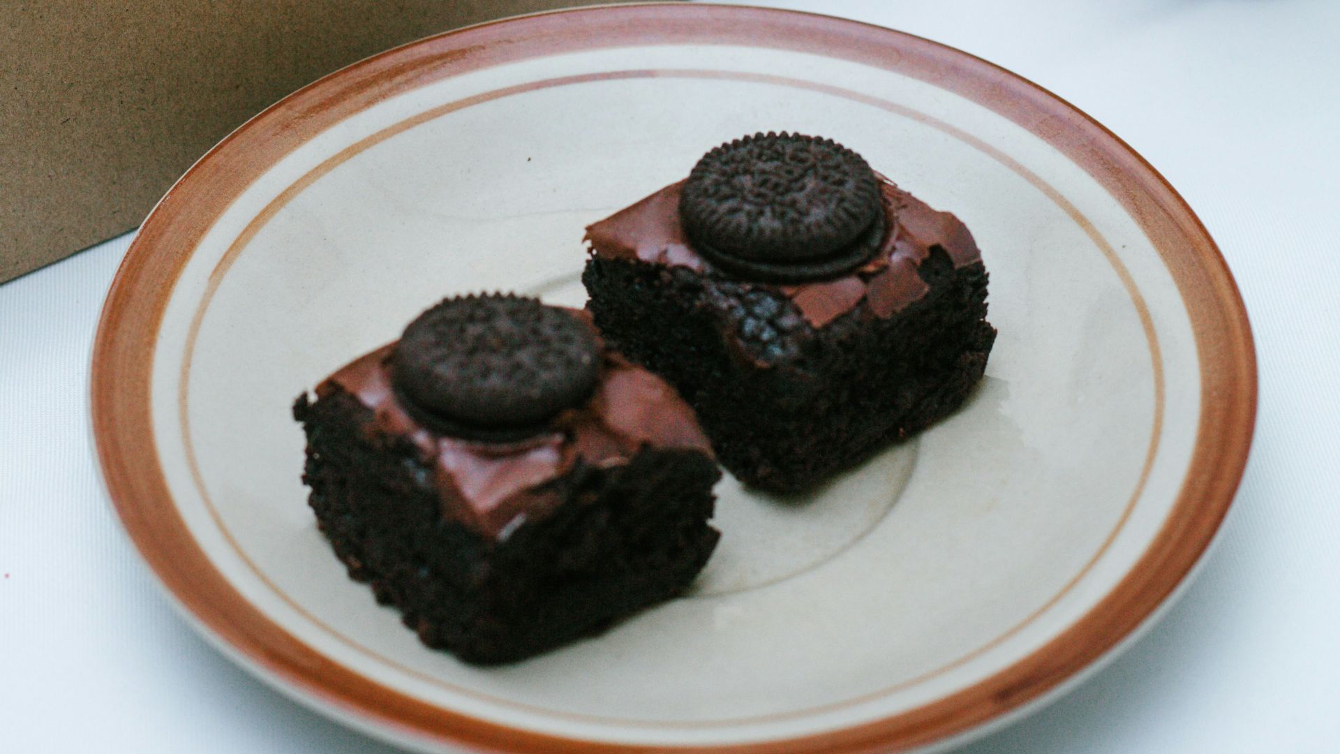 a box of brownies and a plate of cookies