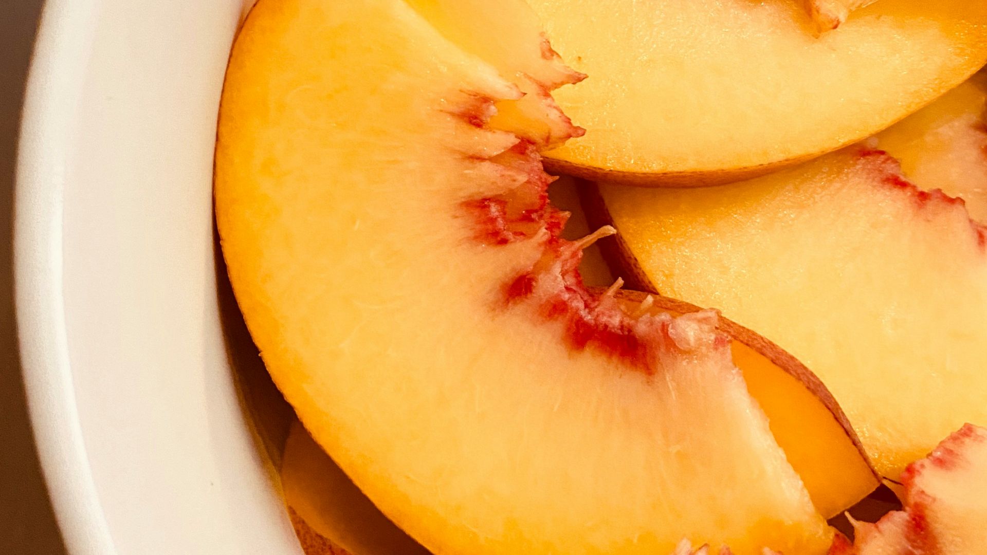 sliced fruit in white ceramic bowl