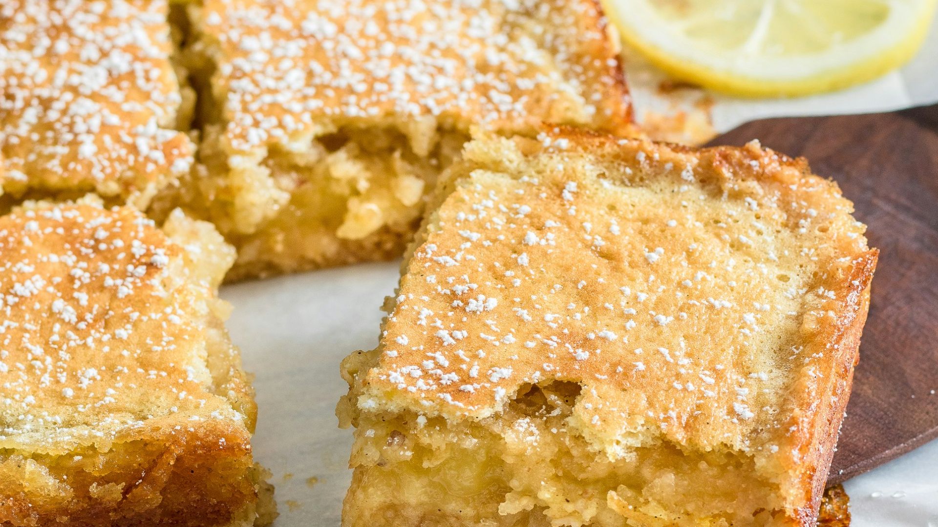 a lemon cake with slices cut out of it