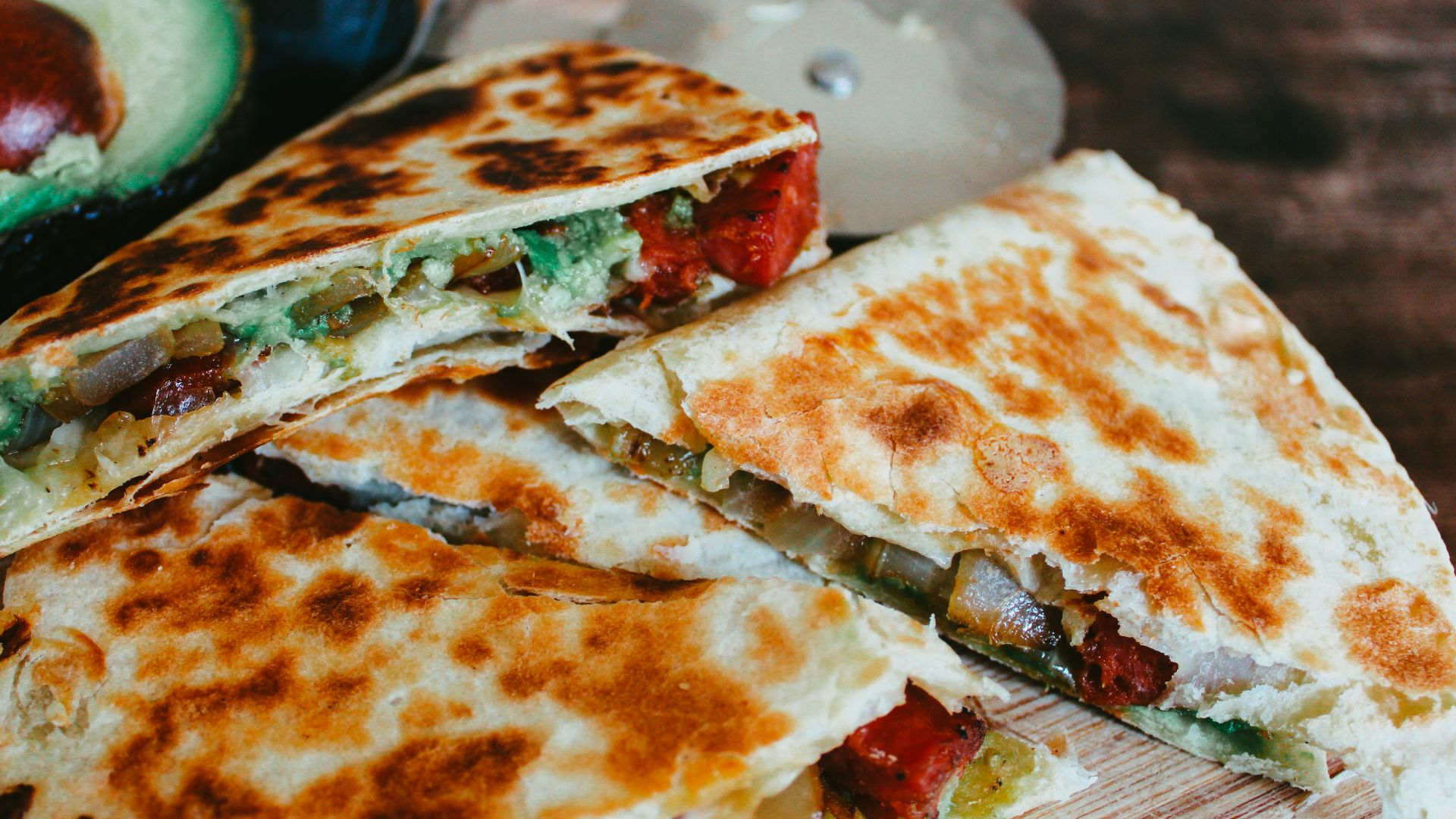 sliced pizza on brown wooden table