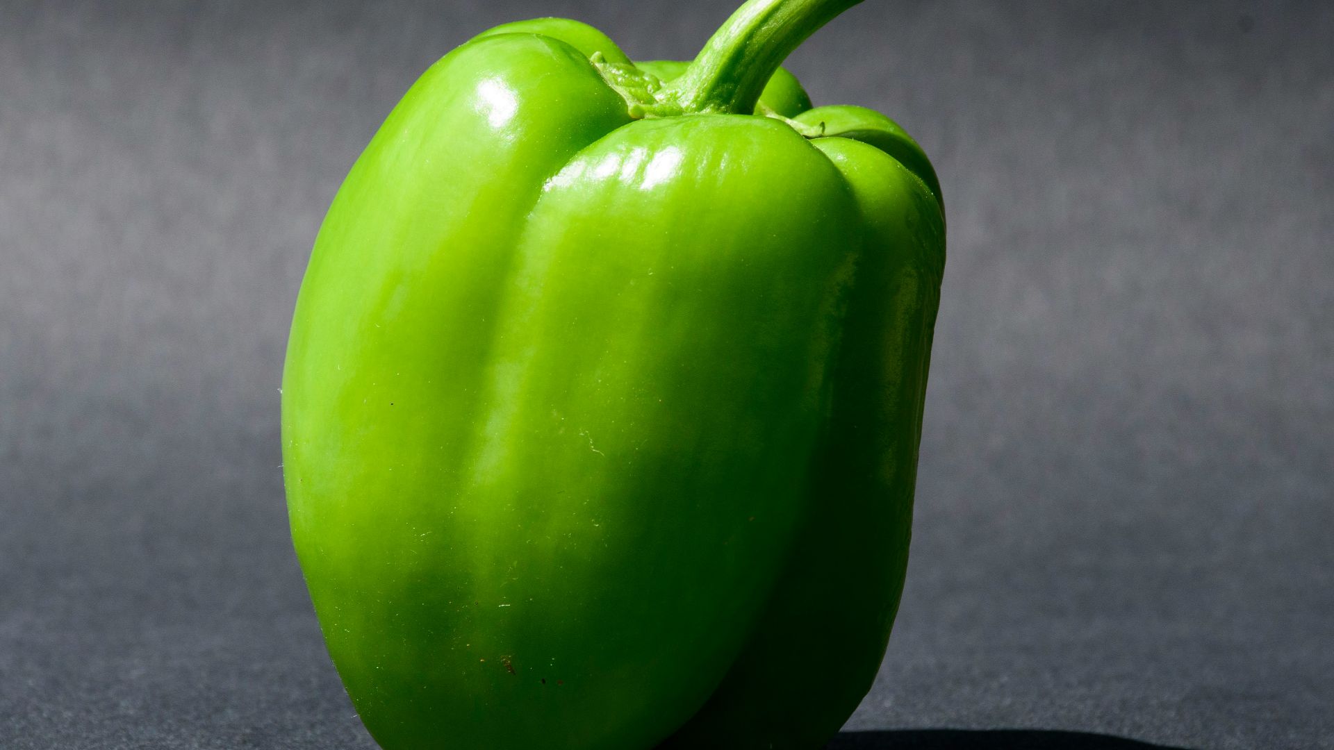 green bell pepper on black textile