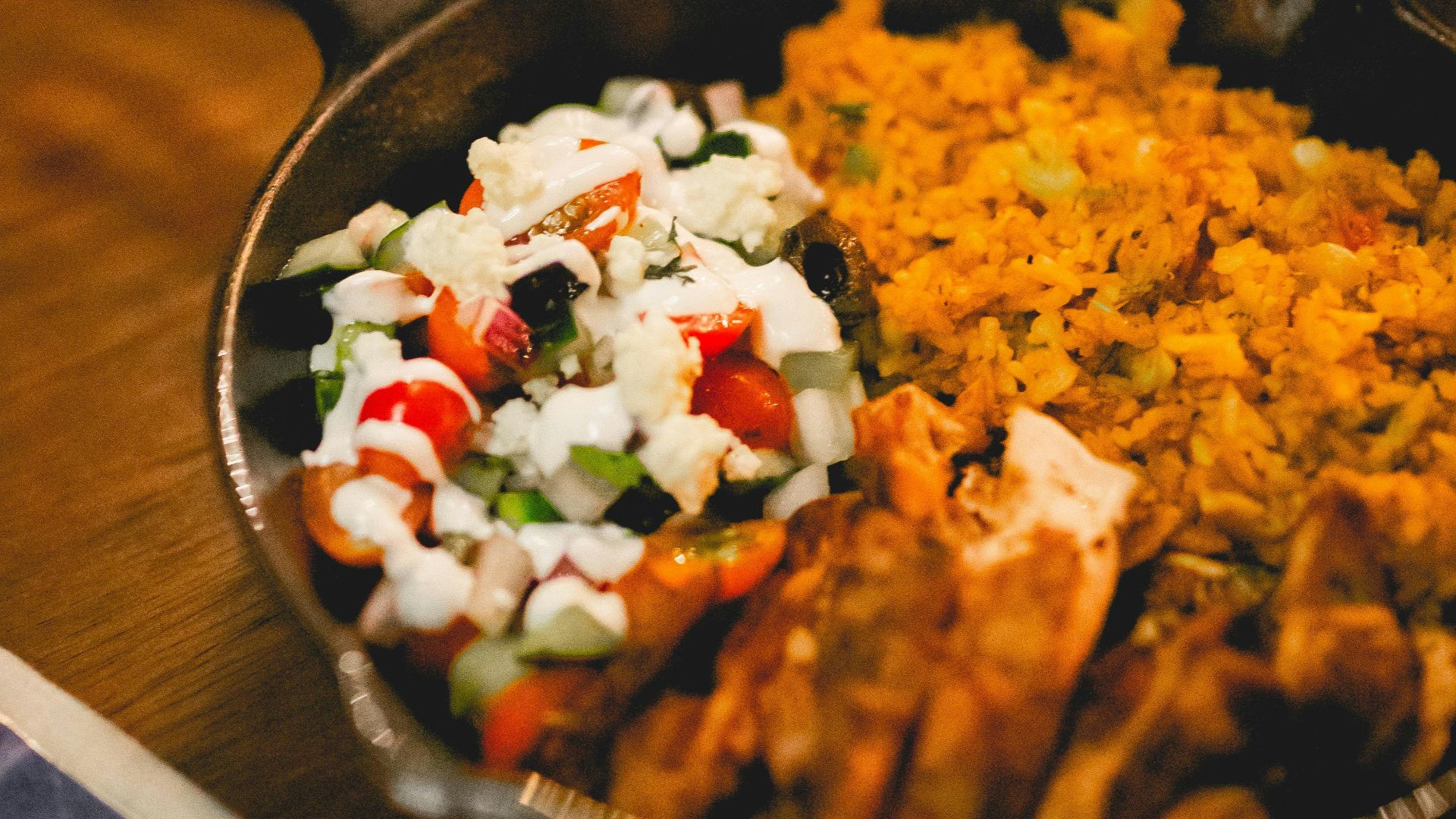 a pan filled with food sitting on top of a wooden table