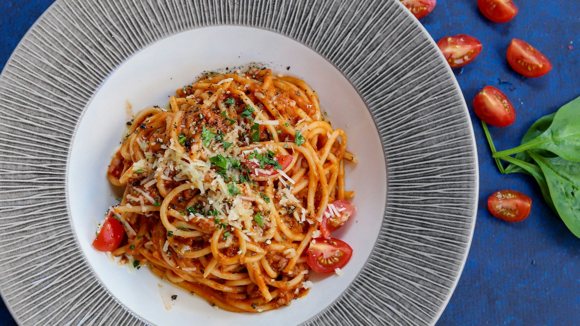 pasta with red sauce on white ceramic round plate