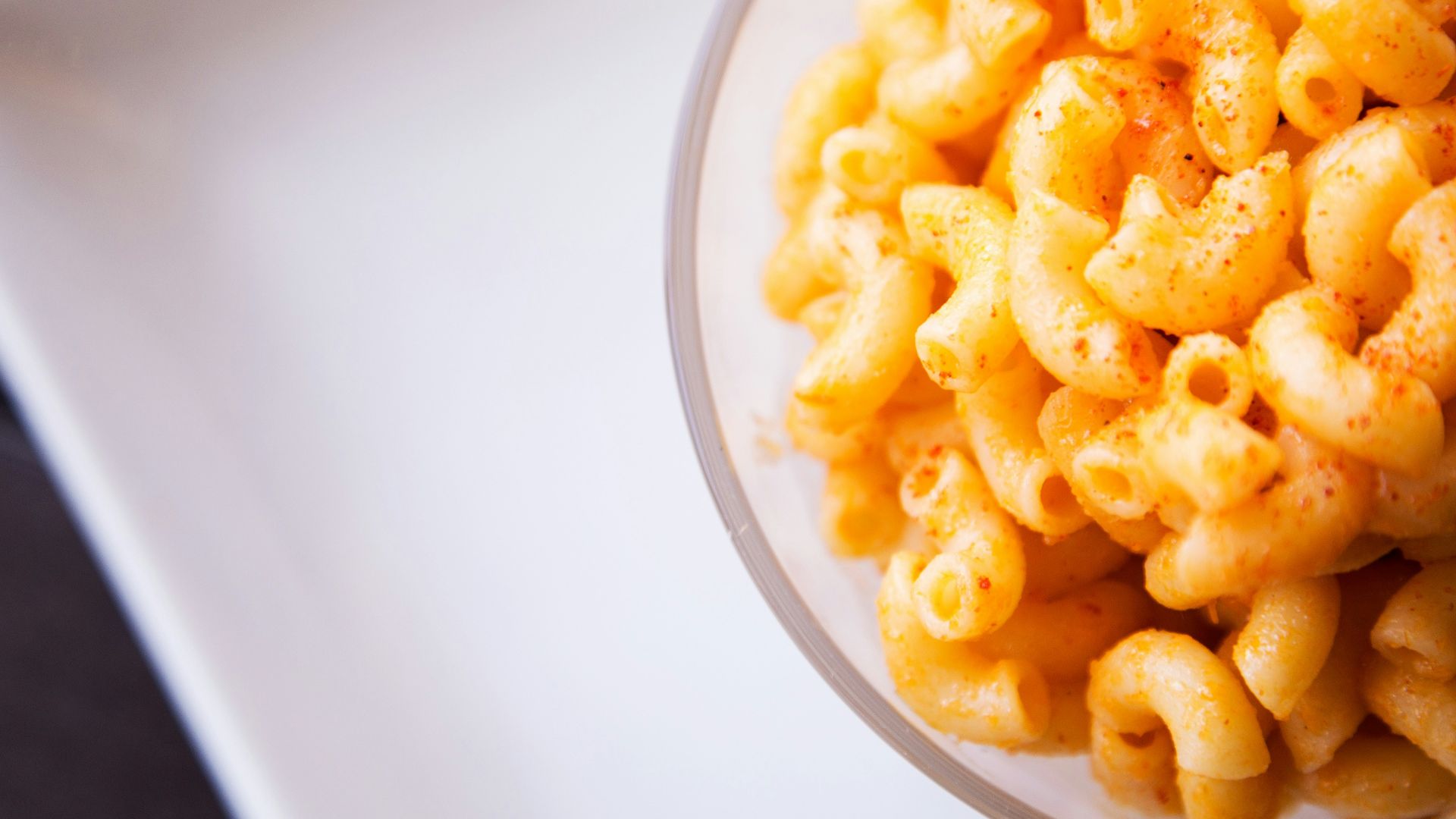 yellow pasta on clear glass bowl