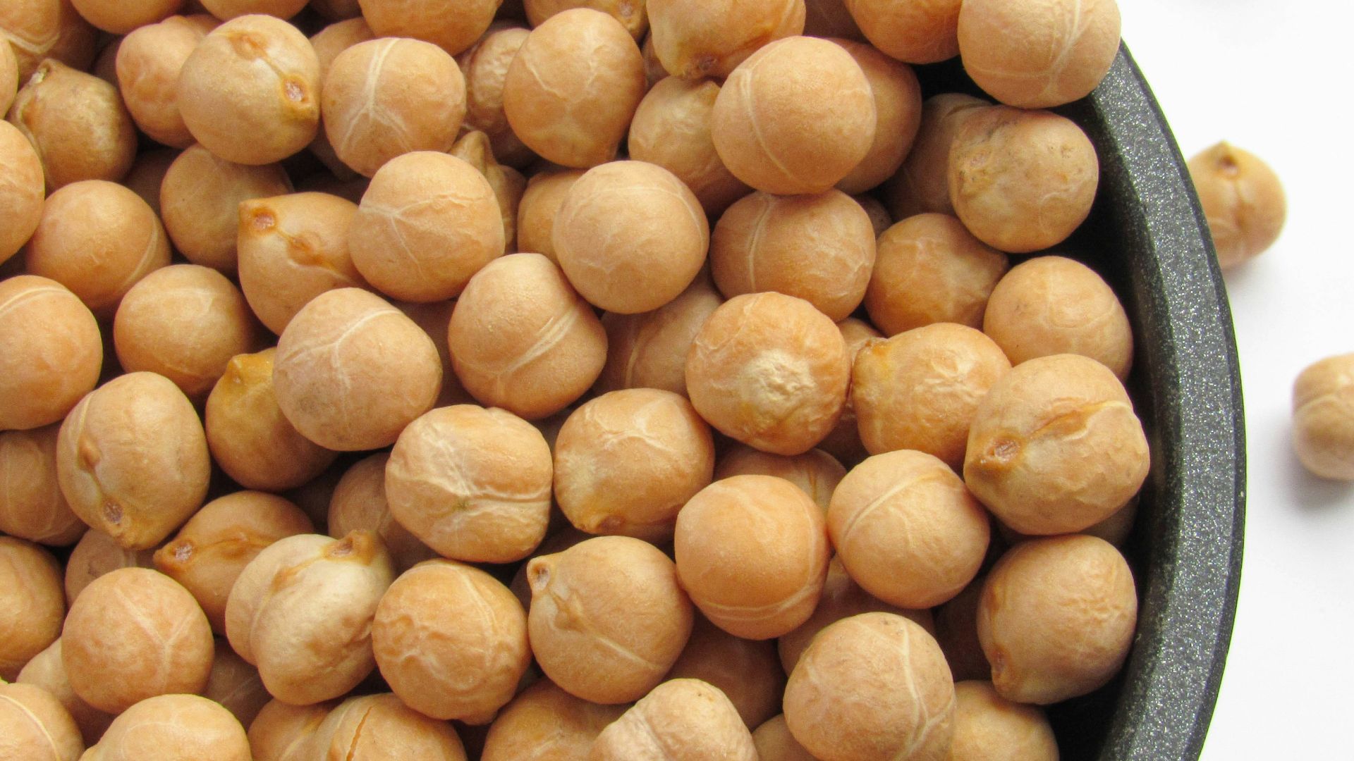 a bowl filled with chickpeas sitting on top of a table