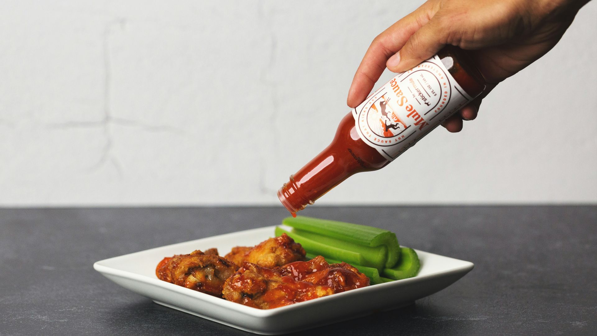 person holding white ceramic plate with food