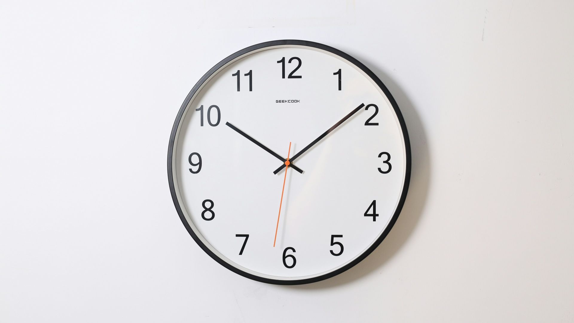 round analog wall clock pointing at 10:09