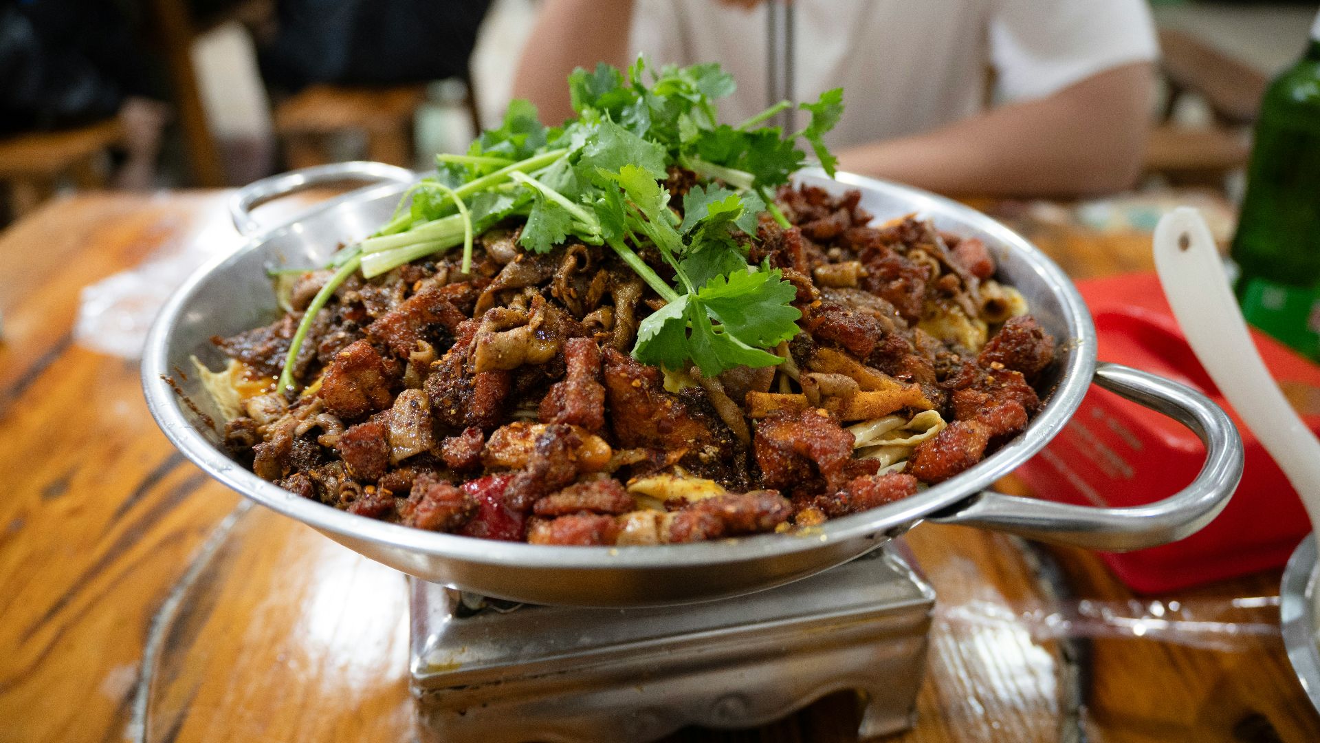 A person sitting at a table with a bowl of food