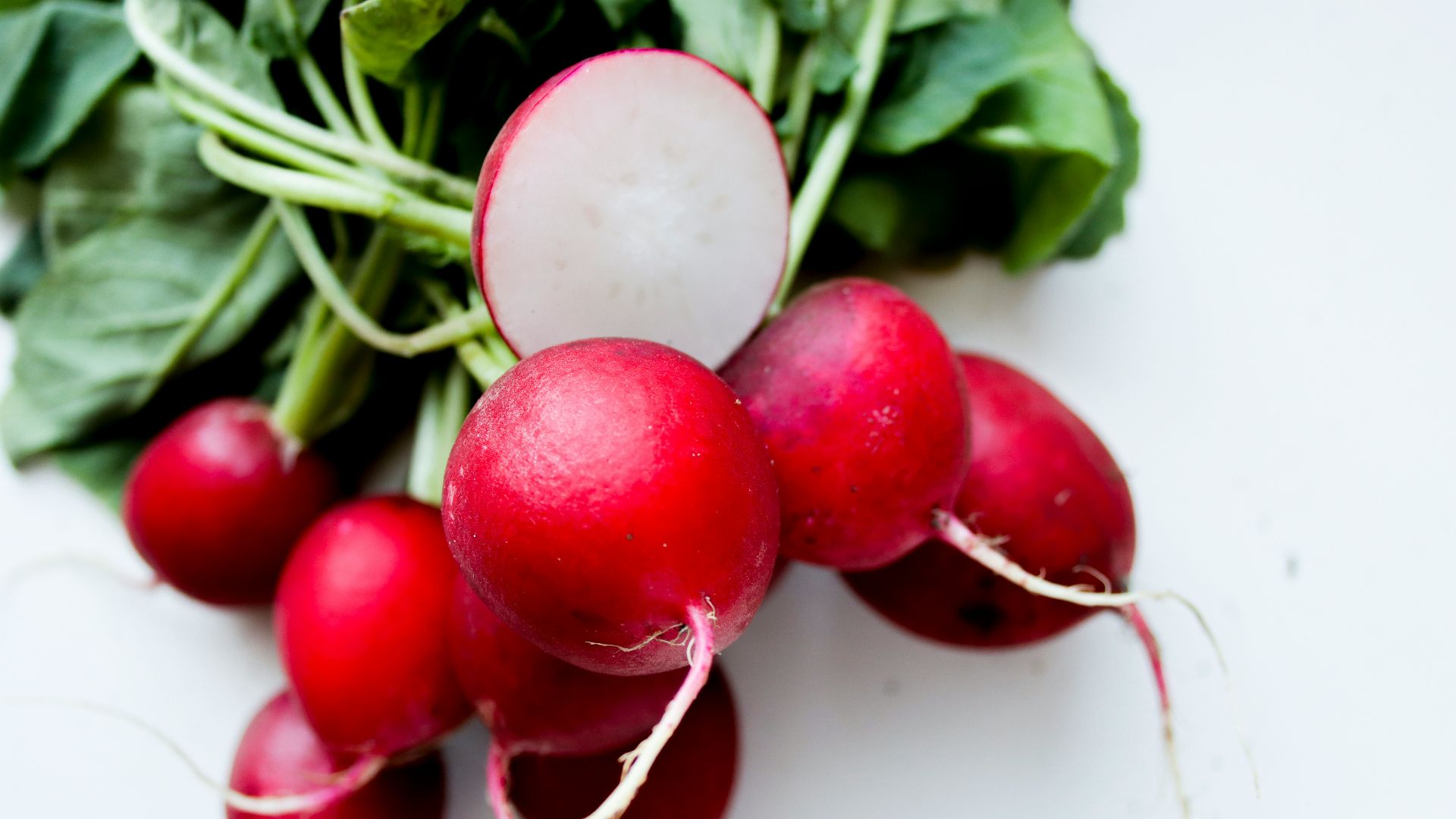 red tomato on white surface