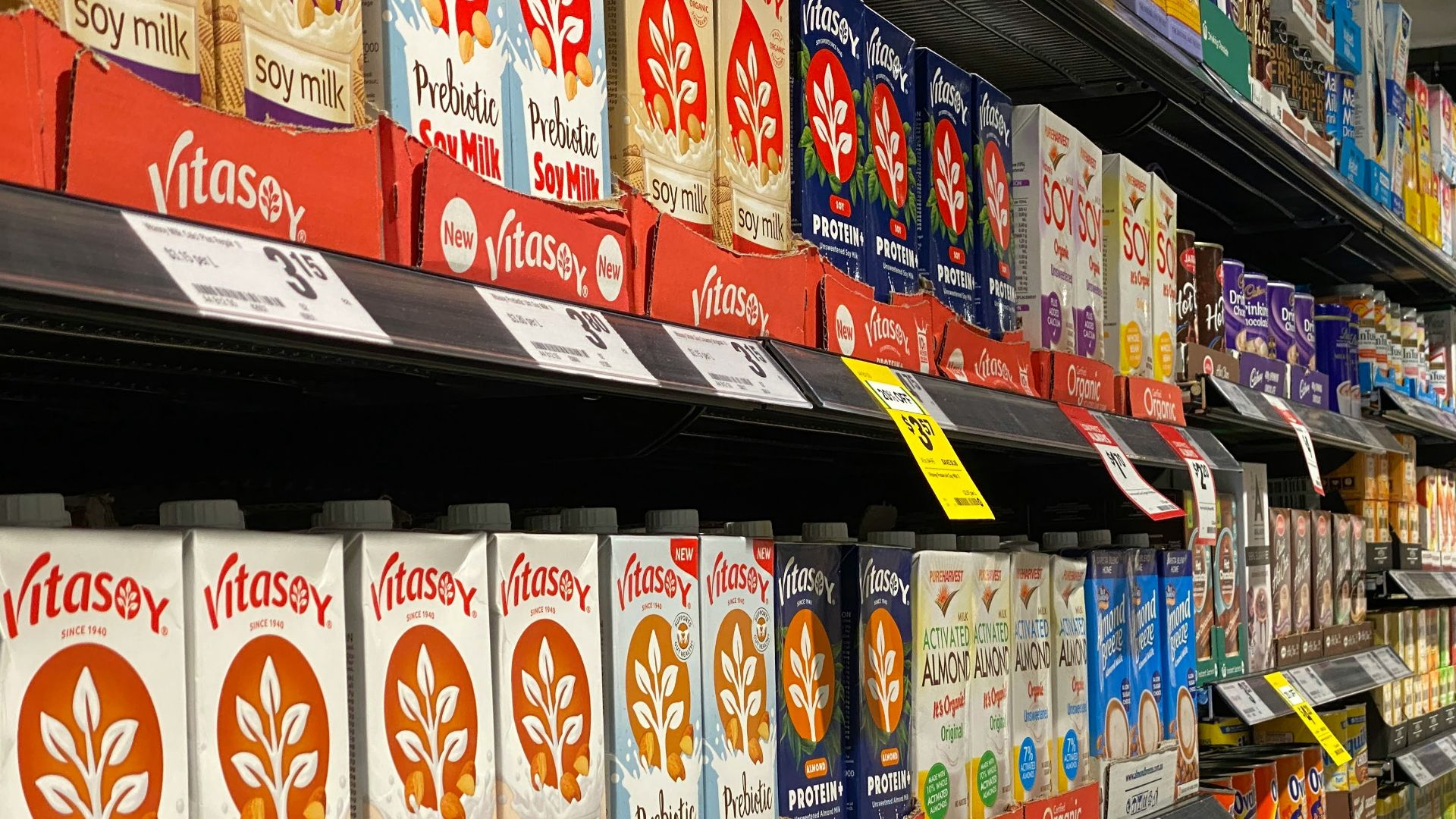 red and white labeled plastic bottle on shelf
