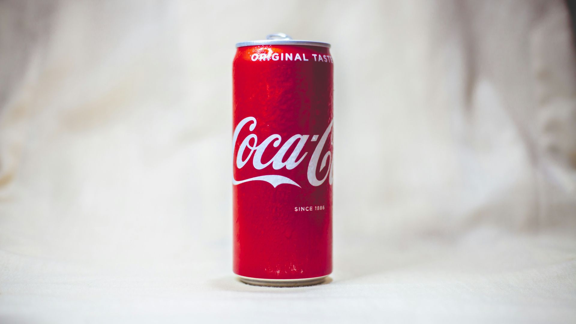 coca cola can on white table