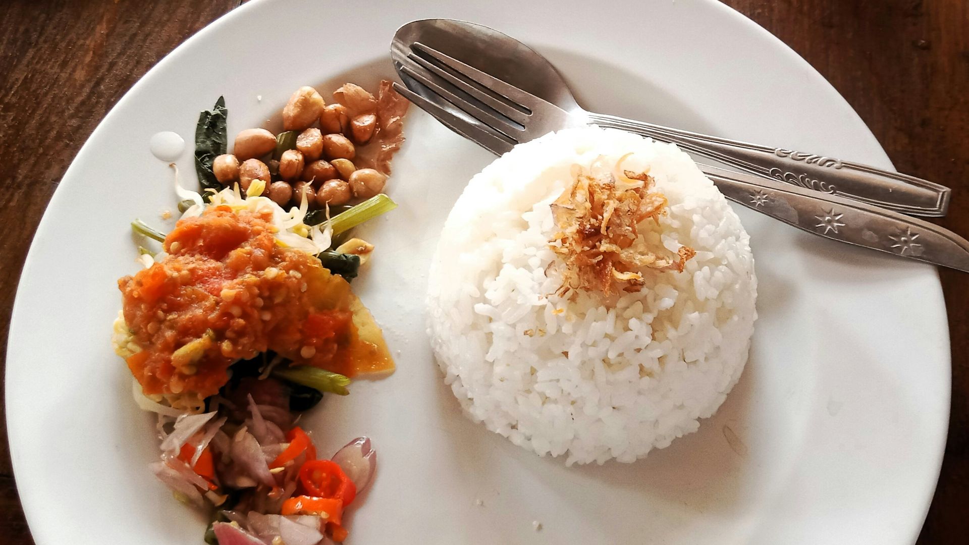 a white plate topped with rice and beans
