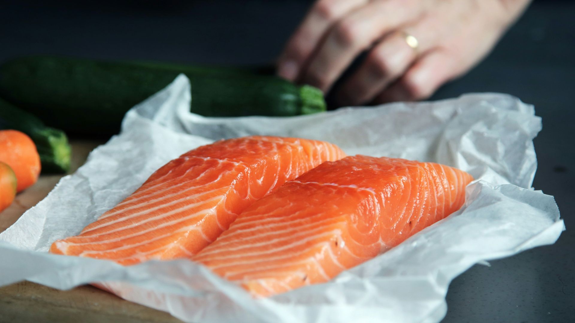 raw fish meat on brown chopping board
