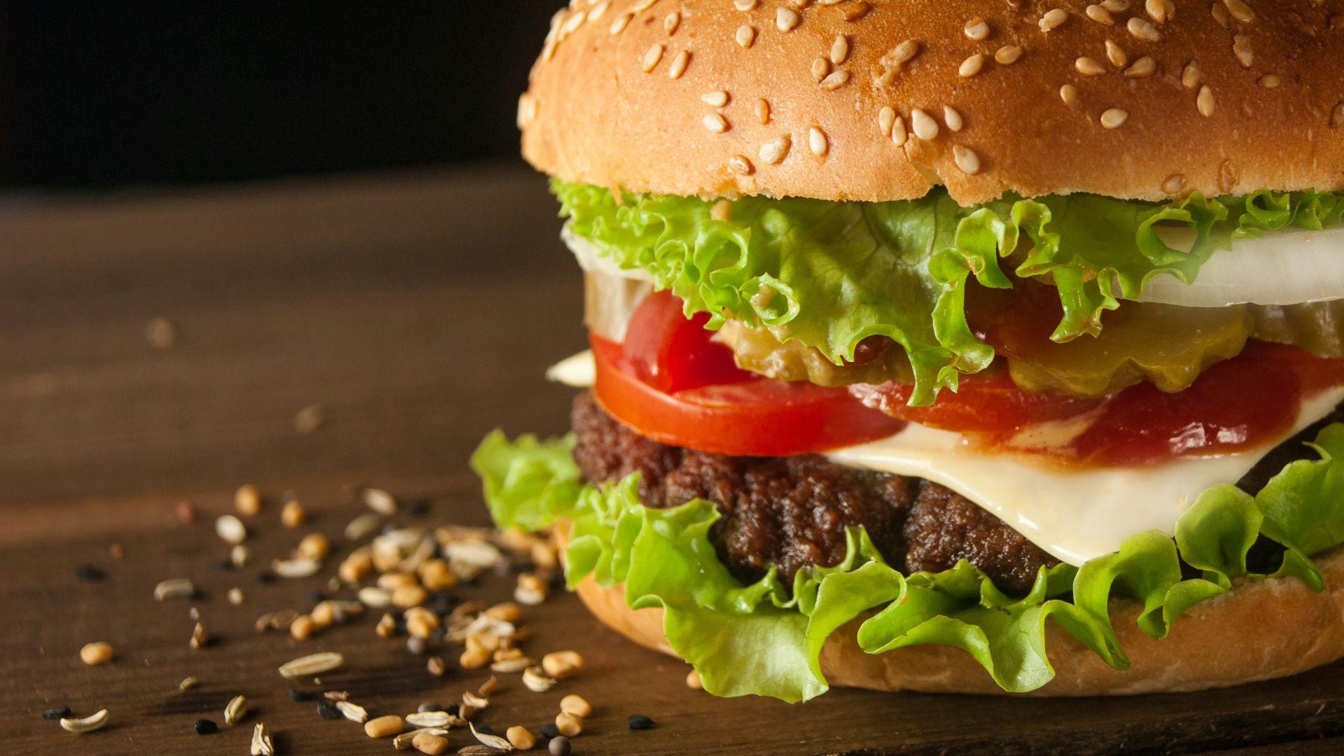 meat and cheese burger surrounded by sesame seeds