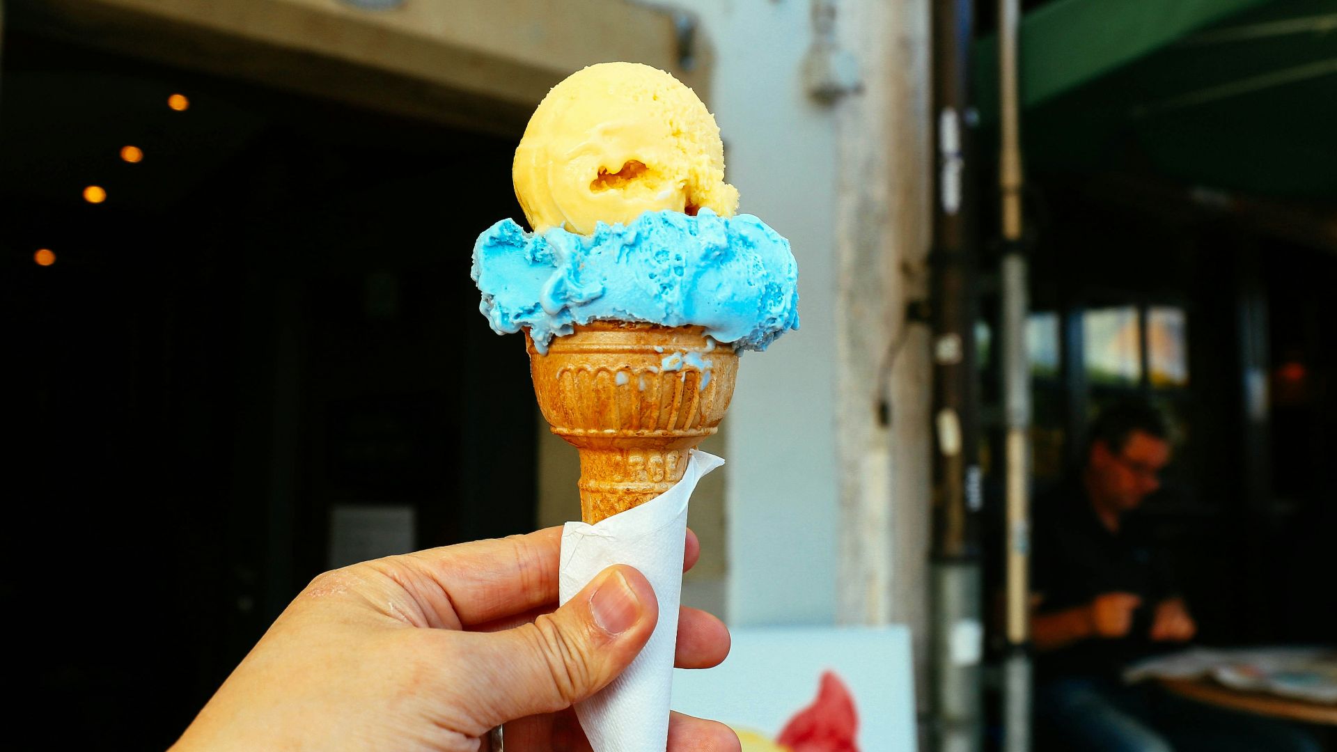 a hand holding a popsicle