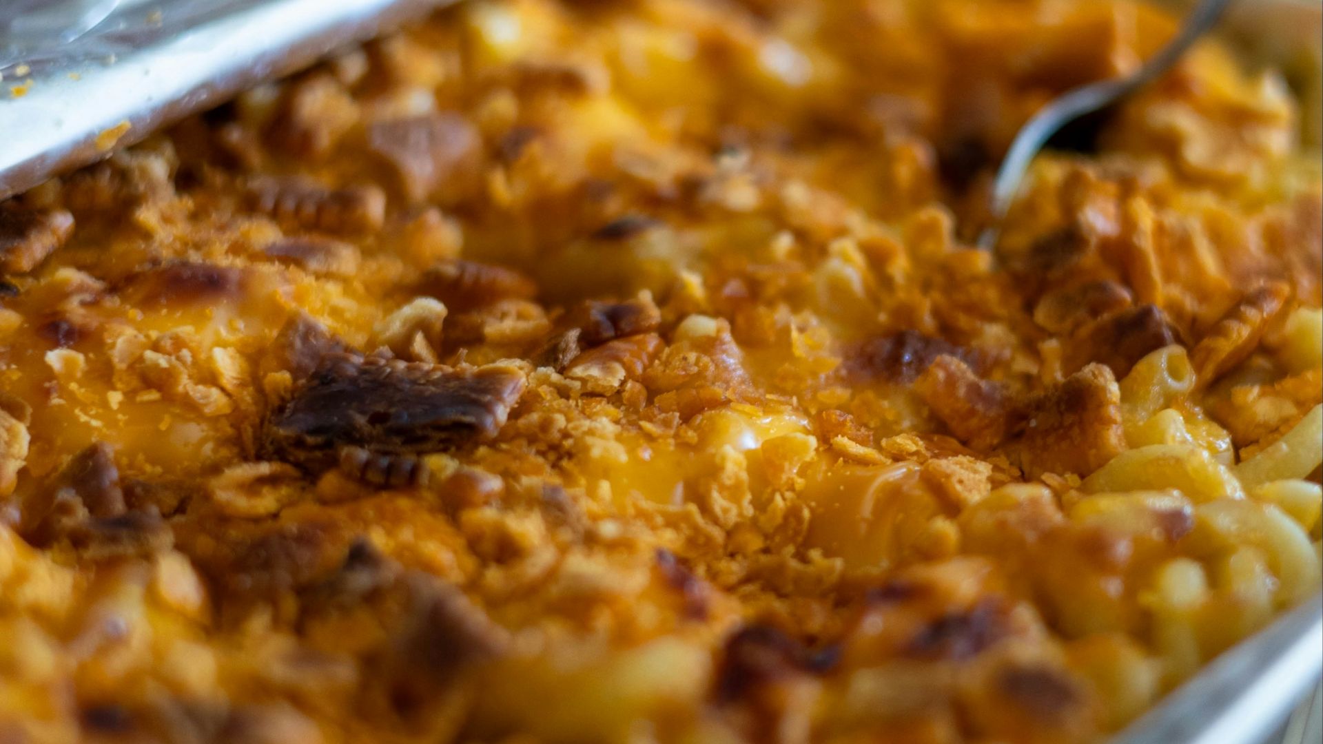 a dish of macaroni and cheese with a spoon in it