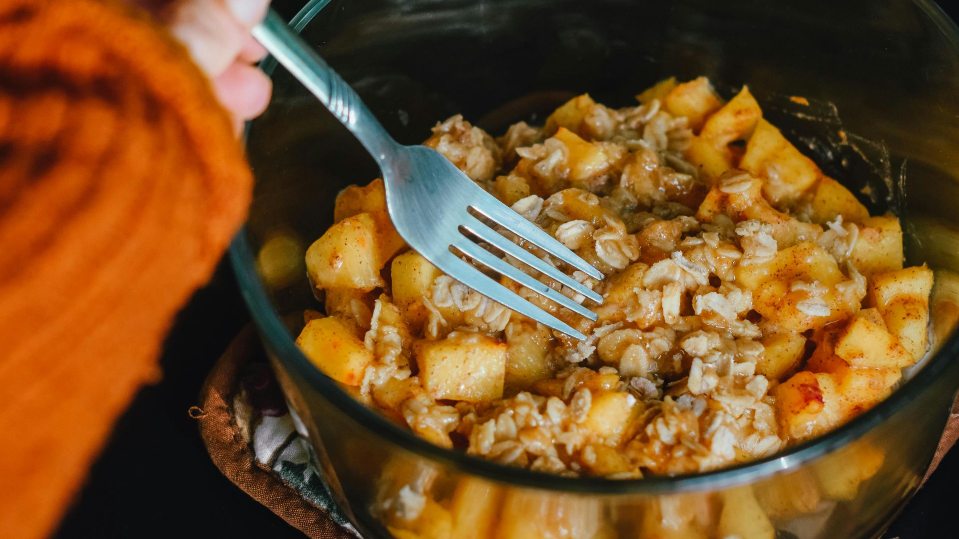 person holding fork getting food