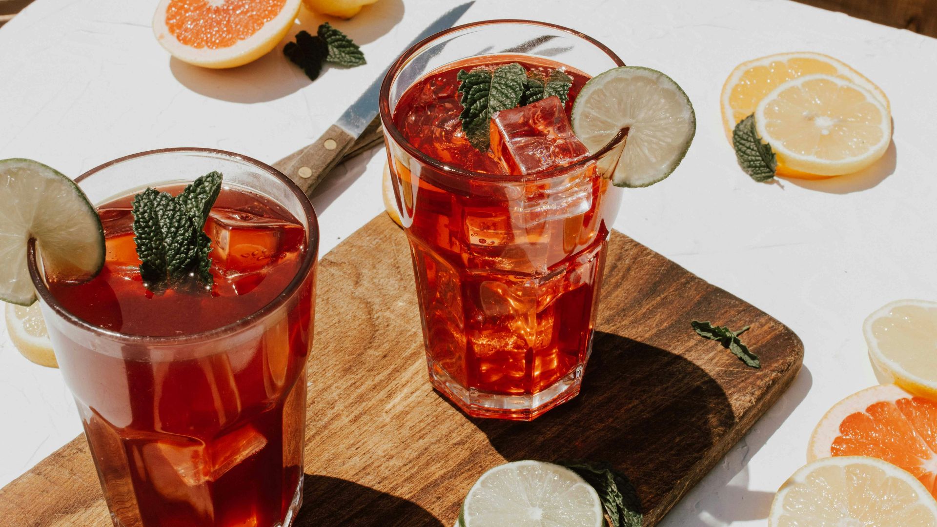 two clear drinking glasses with filled red liquid