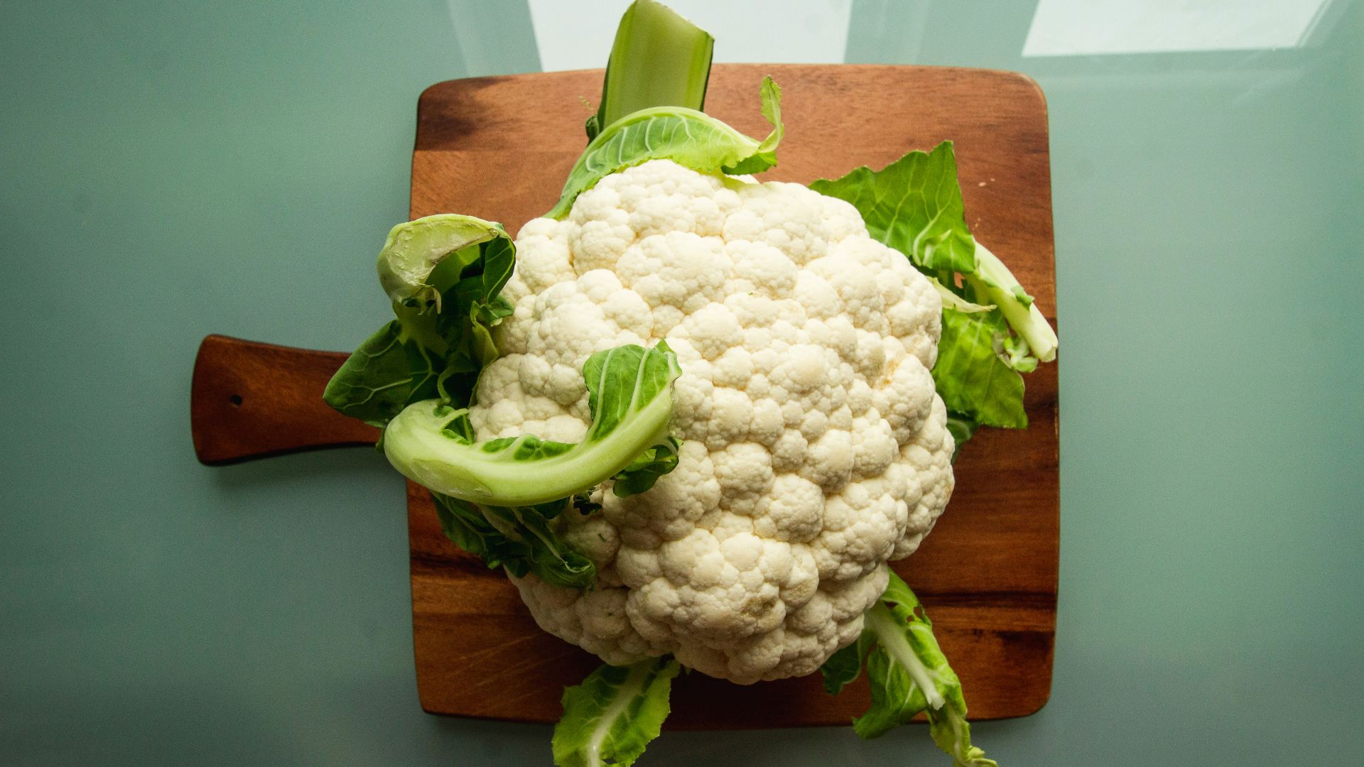 white cauliflower on brown wooden chopping board