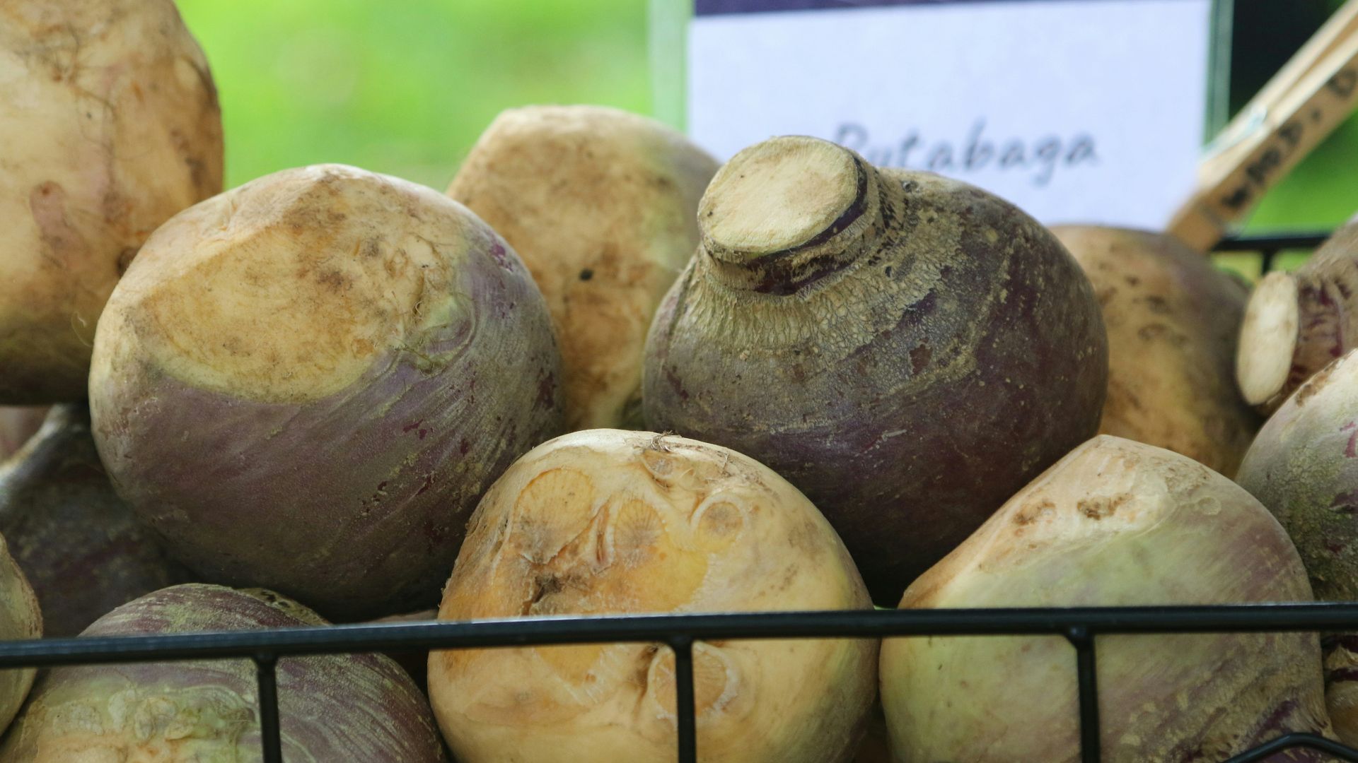 a pile of beets sitting on top of a metal basket