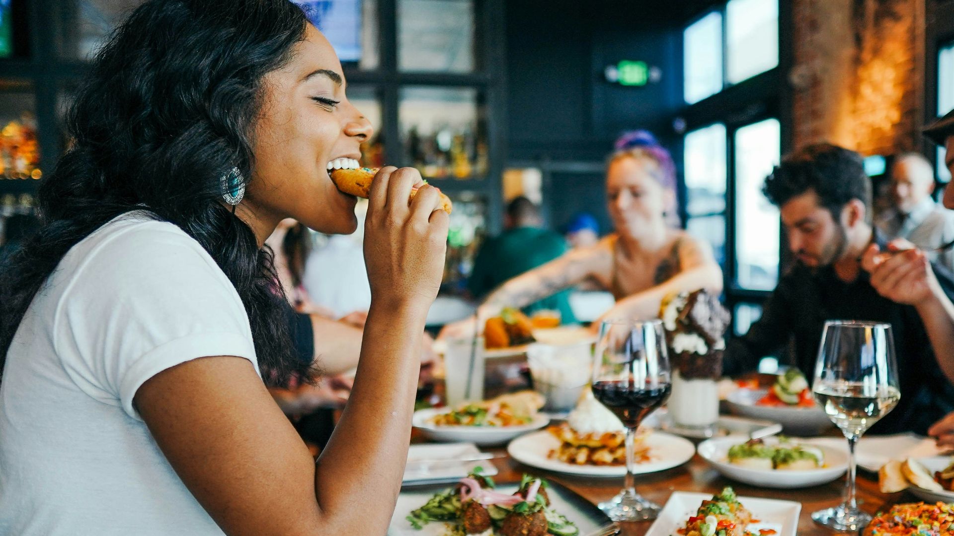 woman in white shirt eating