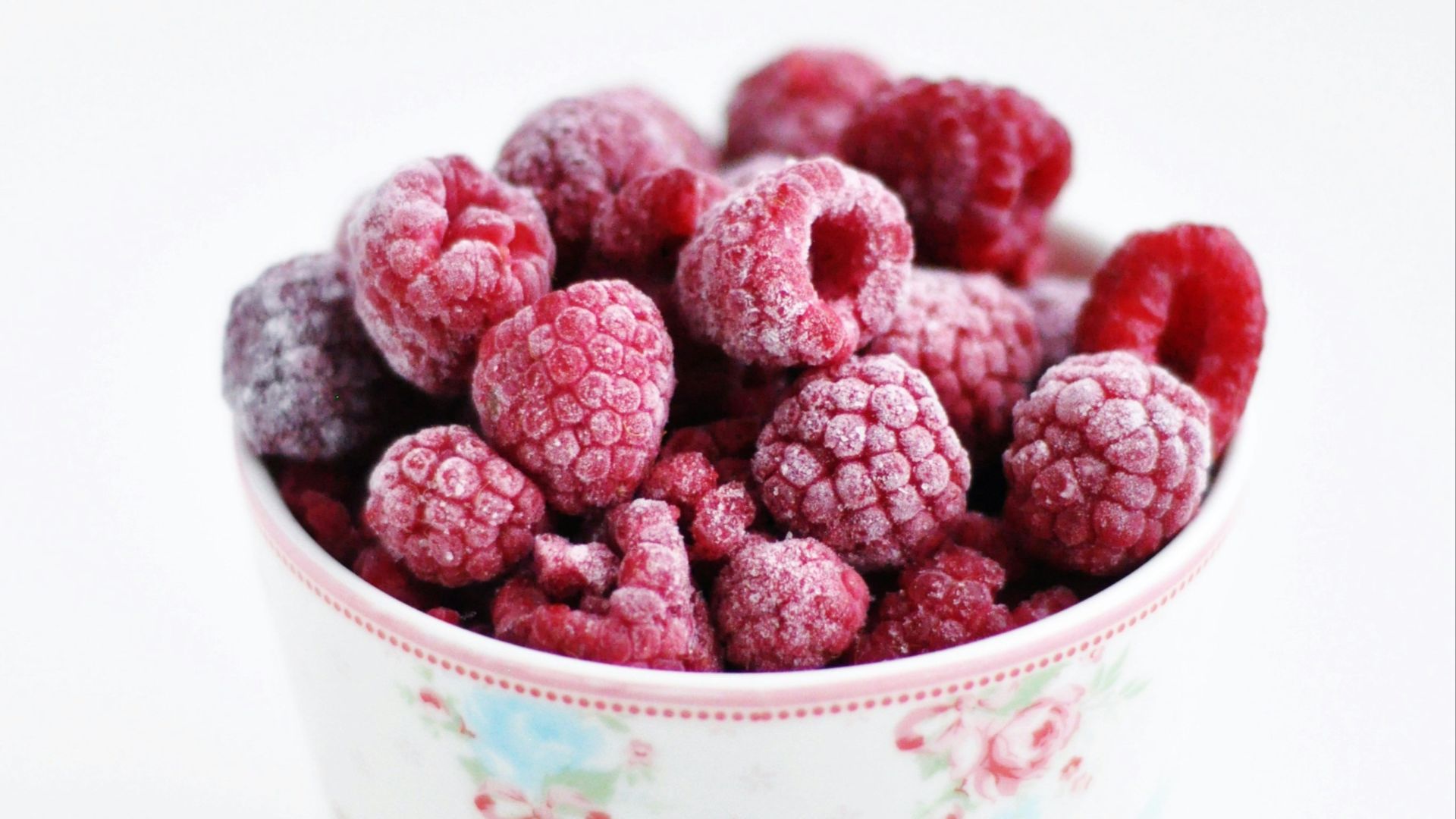 raspberry on white and pink floral ceramic cup